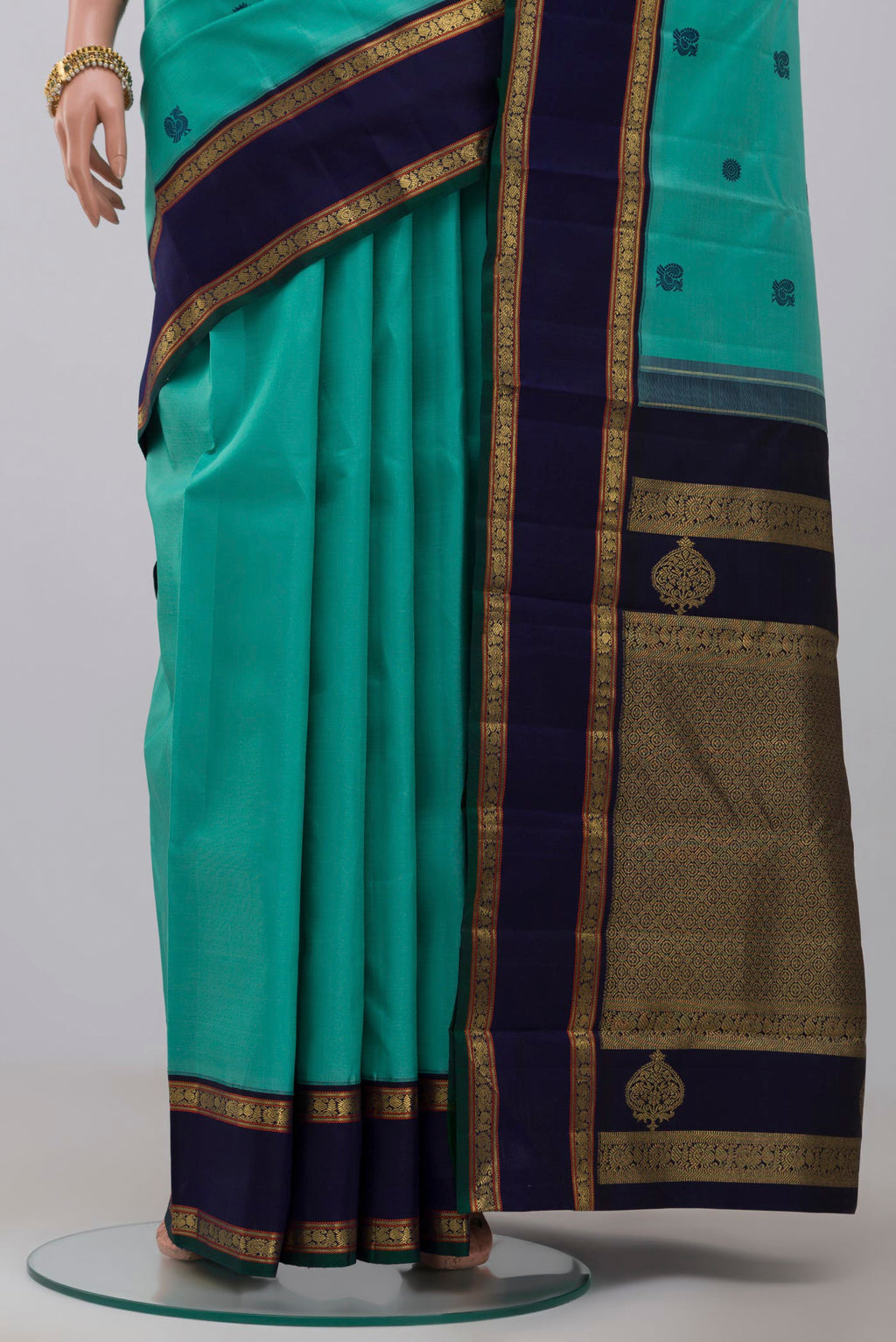 Pleats and pallu of Pure Silk Pure Zari Light Blue Kanchipuram Saree with Thread Butta on the body and Zari Border. 