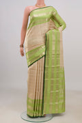 Pure Silk Beige Kanchipuram Saree with Stripes on the body and Zari Border.  displayed on a mannequin