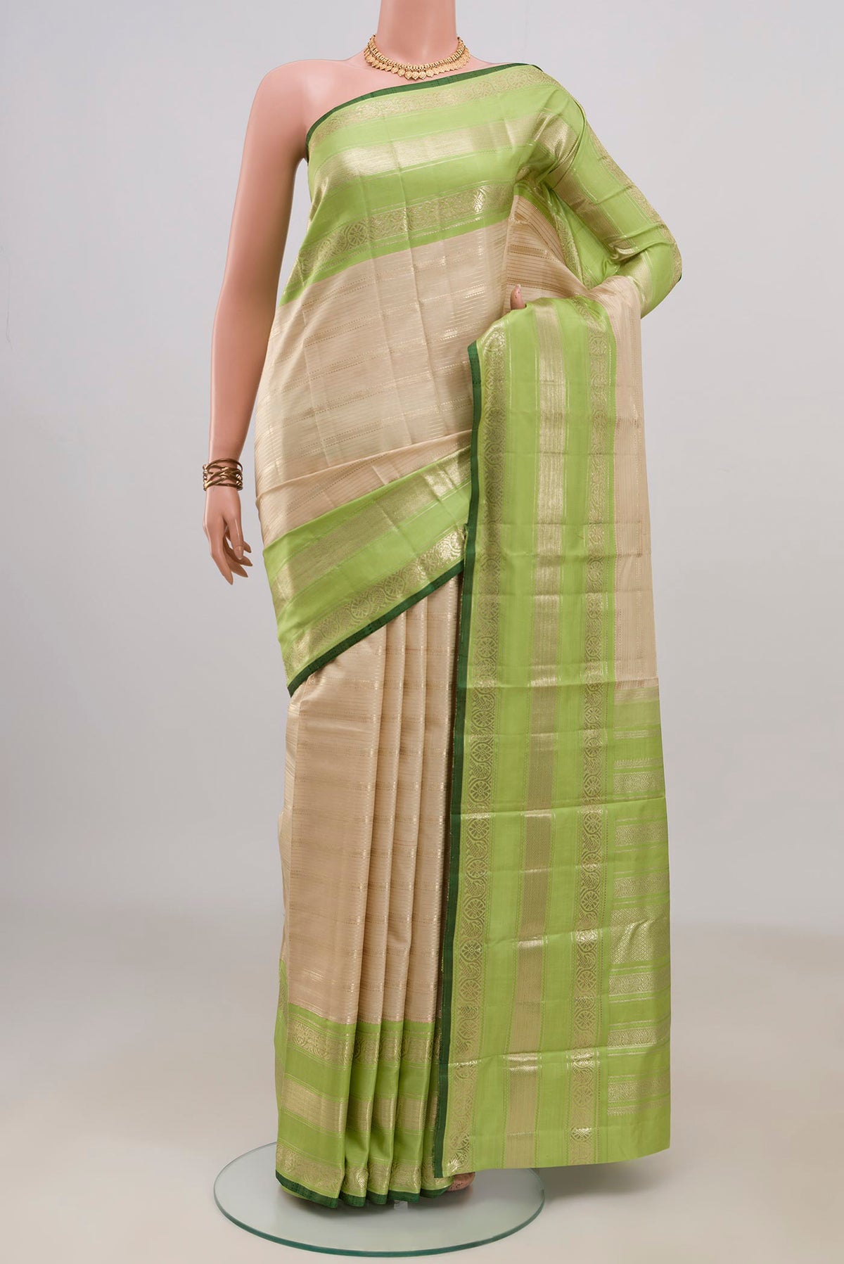 Pure Silk Beige Kanchipuram Saree with Stripes on the body and Zari Border.  displayed on a mannequin