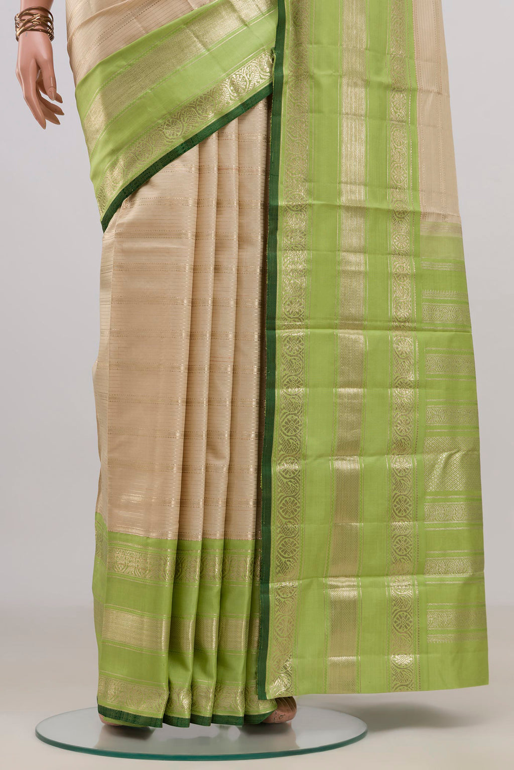 Pleats and pallu of Pure Silk Beige Kanchipuram Saree with Stripes on the body and Zari Border. 