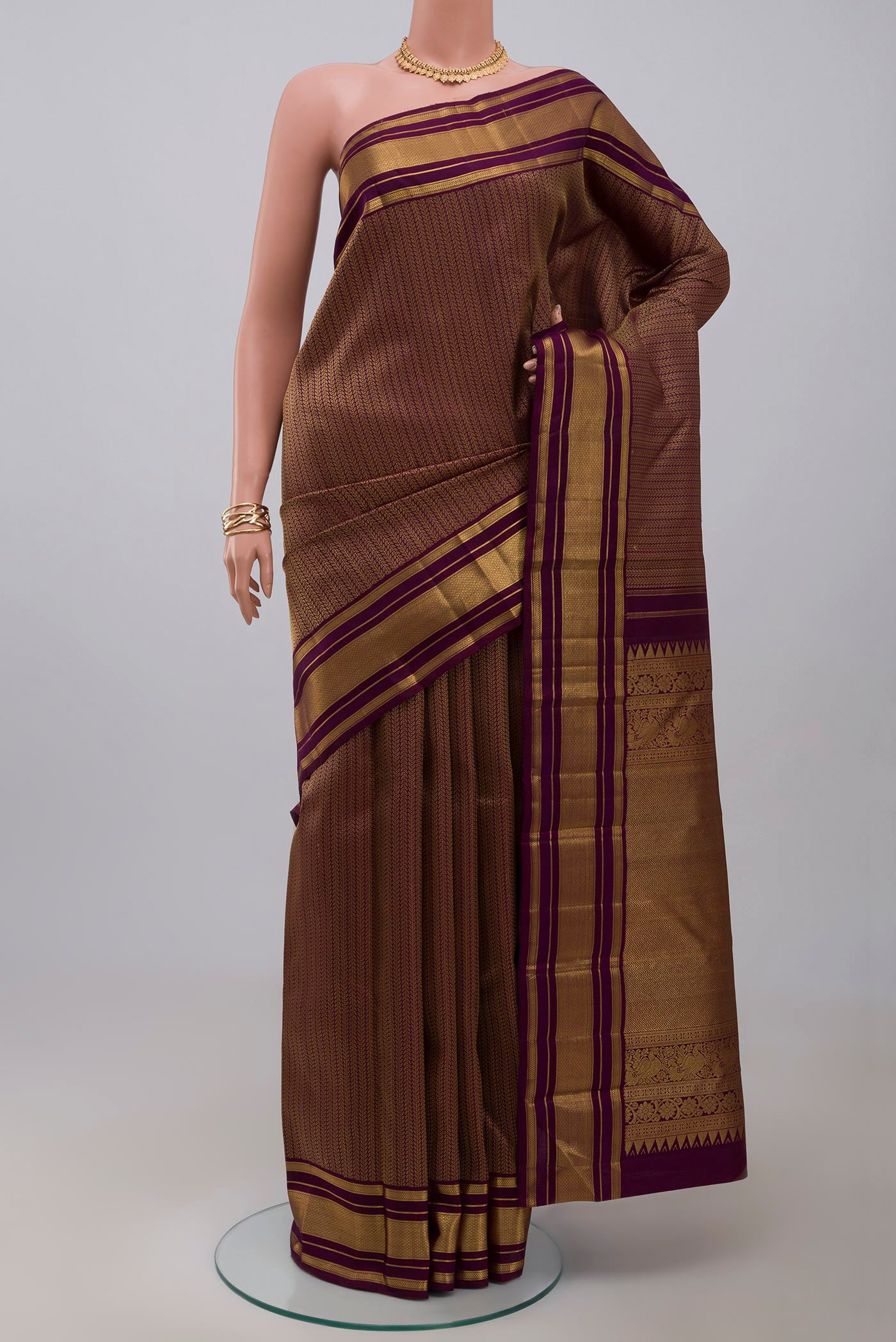 Pure Silk Pure Zari Purple Kanchipuram Saree with Jacquard design on the body and Zari Border.  displayed on a mannequin