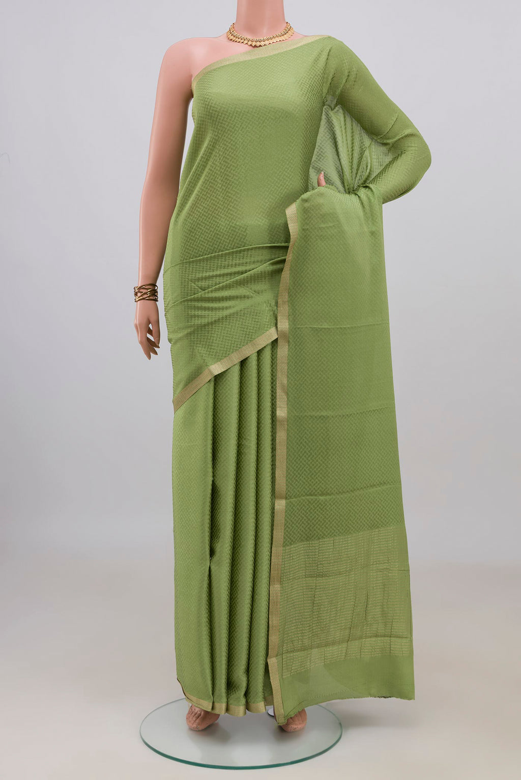 Green Mysore Crepe Saree with Jacquard design on the body and Zari Border.  displayed on a mannequin