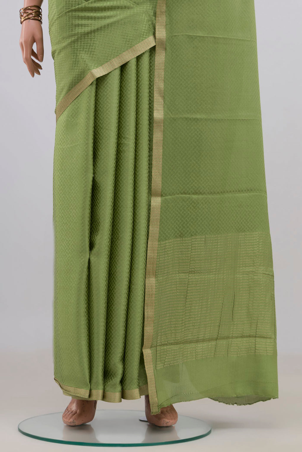 Pleats and pallu of Green Mysore Crepe Saree with Jacquard design on the body and Zari Border. 