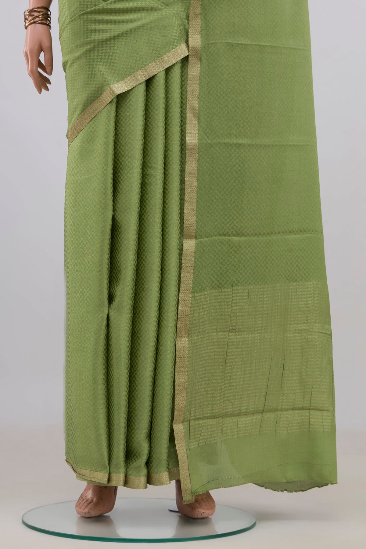 Pleats and pallu of Green Mysore Crepe Saree with Jacquard design on the body and Zari Border. 