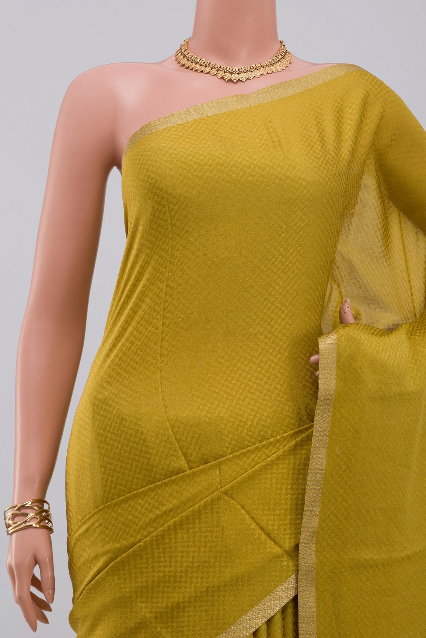 Border image of Yellow Crepe Saree with Fancy on the body and Zari Border. 