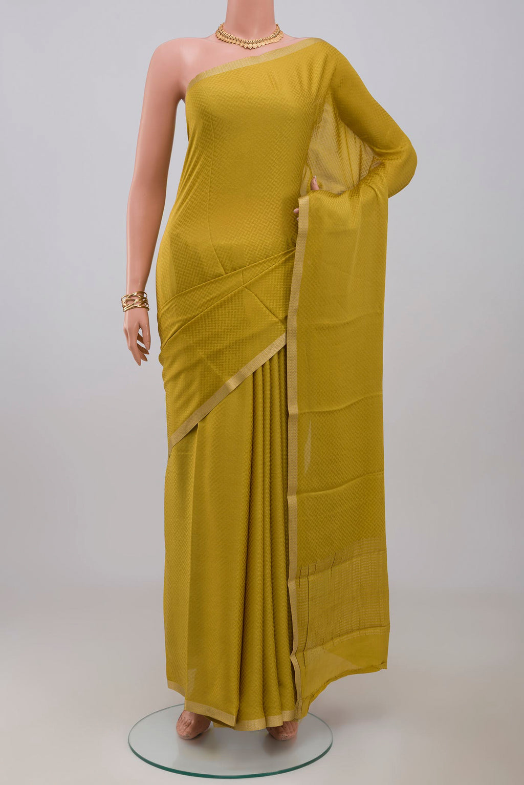 Yellow Crepe Saree with Fancy on the body and Zari Border.  displayed on a mannequin