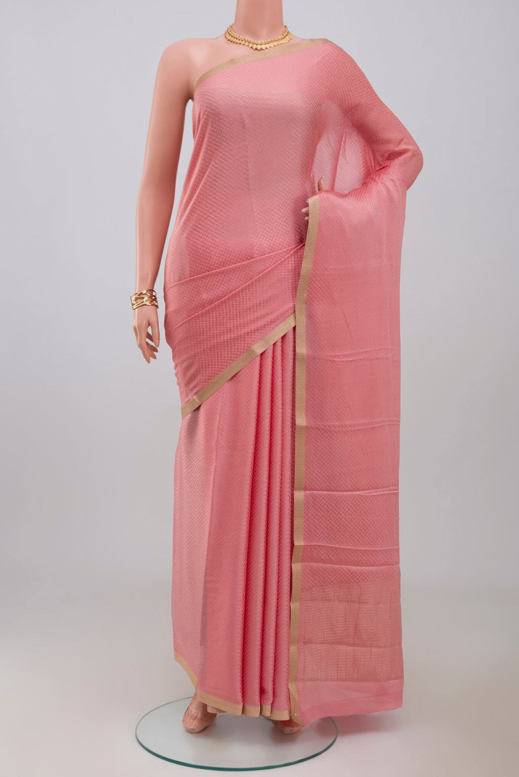 Pink Crepe Saree with Fancy on the body and Zari Border.  displayed on a mannequin
