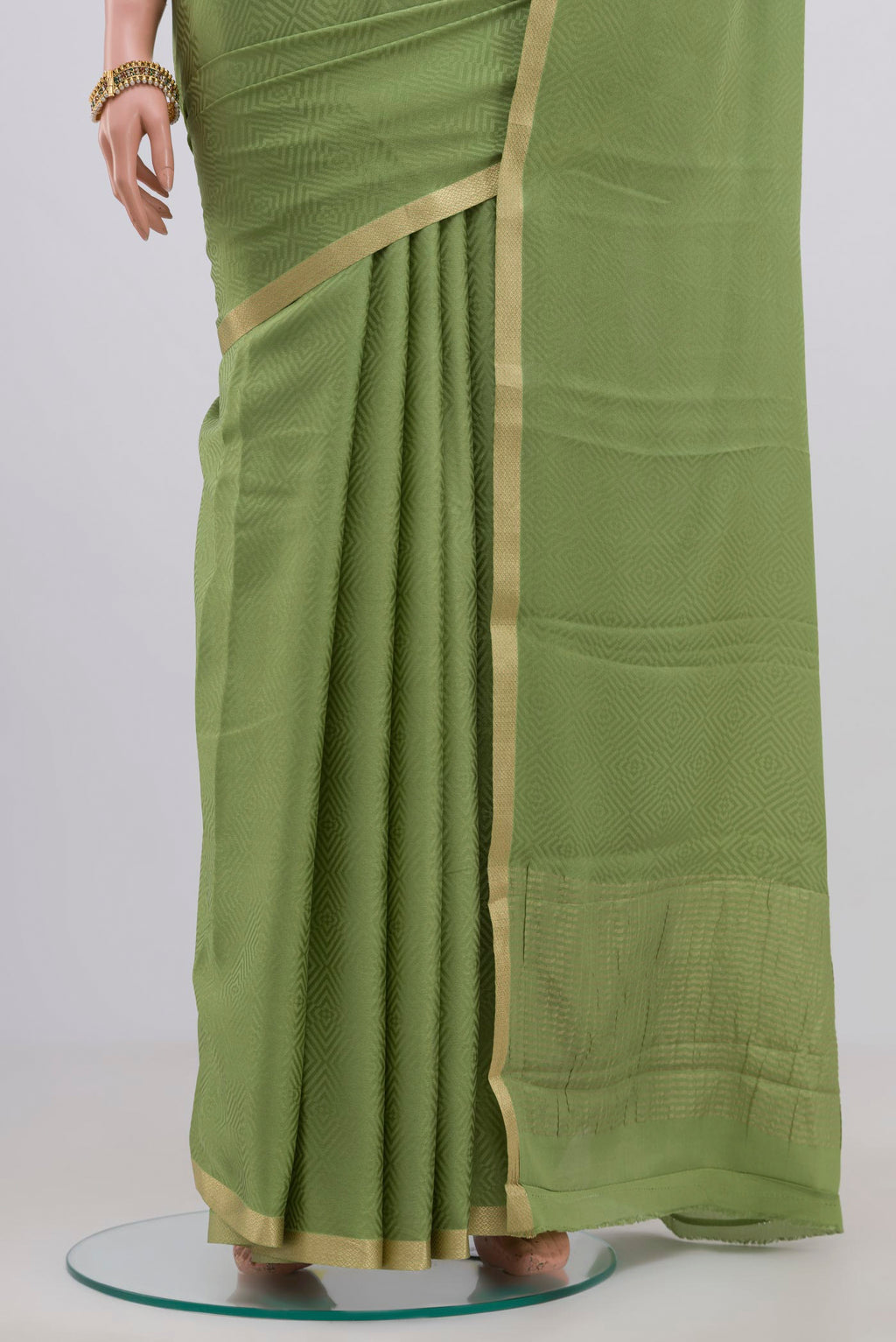 Pleats and pallu of Green Crepe Saree with Jacquard design on the body and Zari Border. 