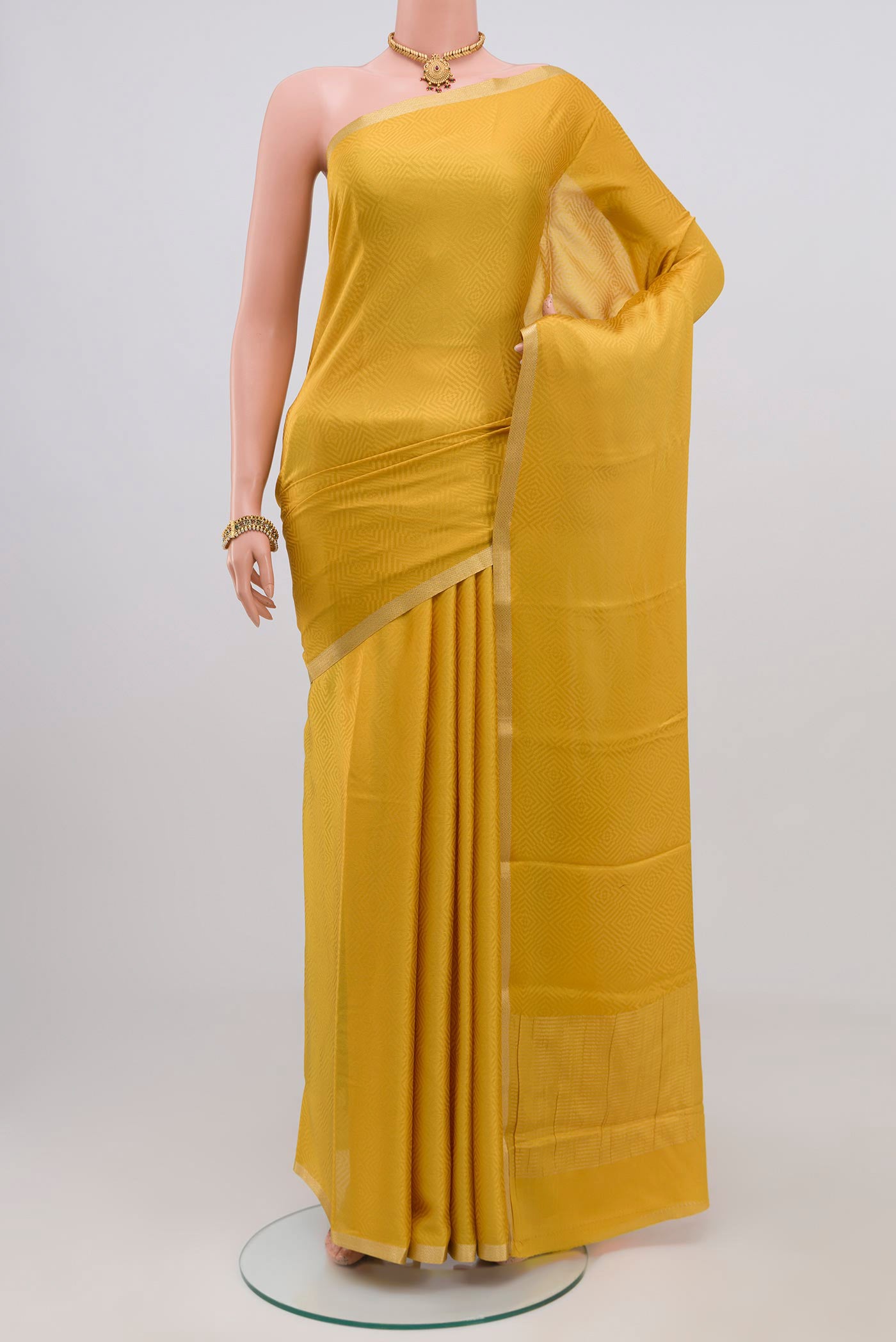 Yellow Crepe Saree with Jacquard design on the body and Thin Zari Line.  displayed on a mannequin
