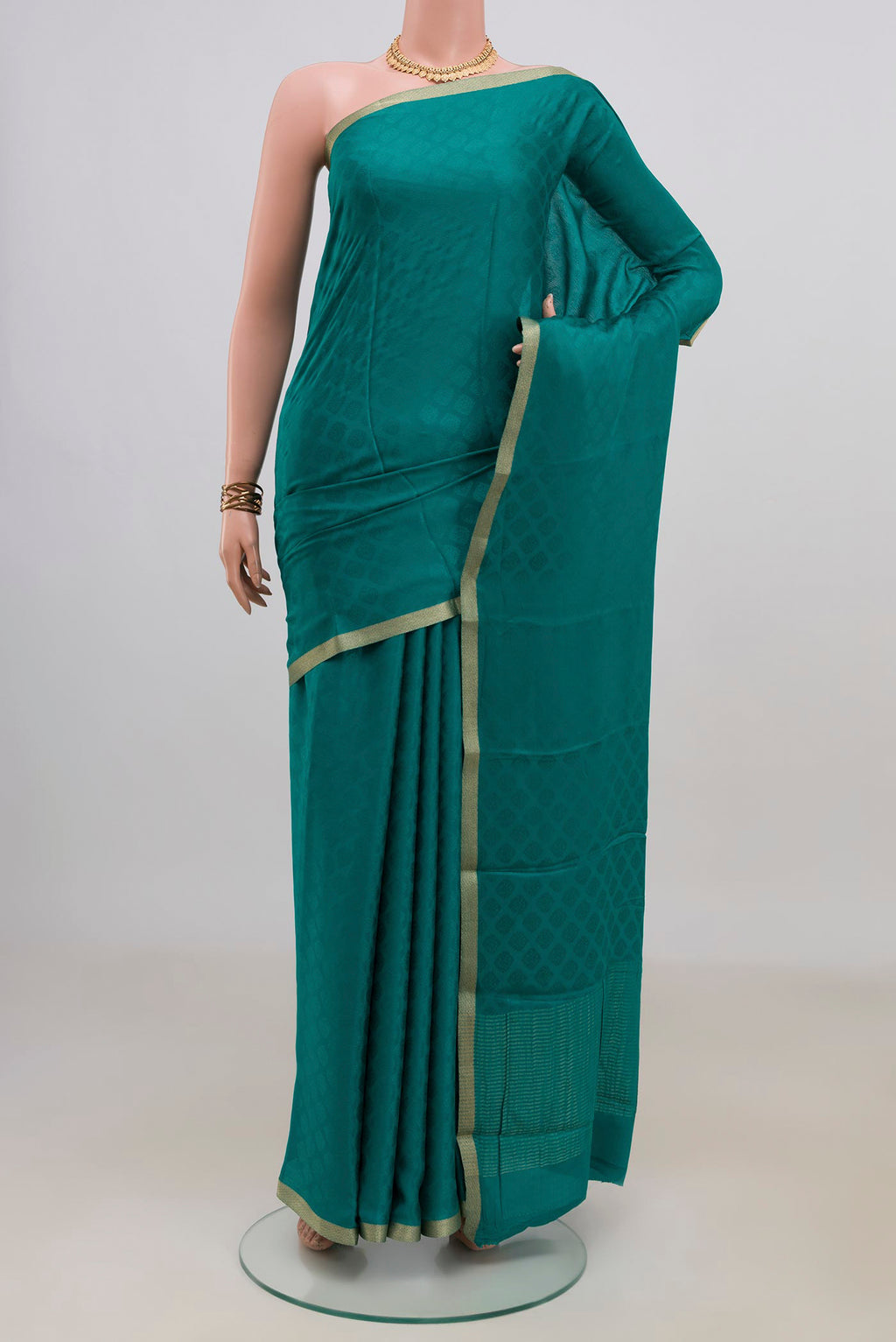 Teal Mysore Crepe Saree with Jacquard design on the body and Zari Border.  displayed on a mannequin
