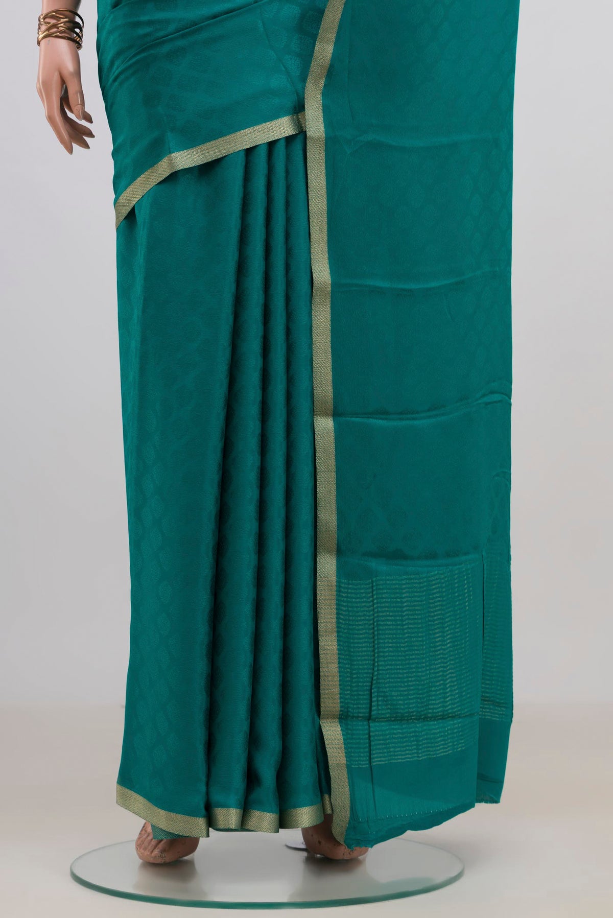 Pleats and pallu of Teal Mysore Crepe Saree with Jacquard design on the body and Zari Border. 