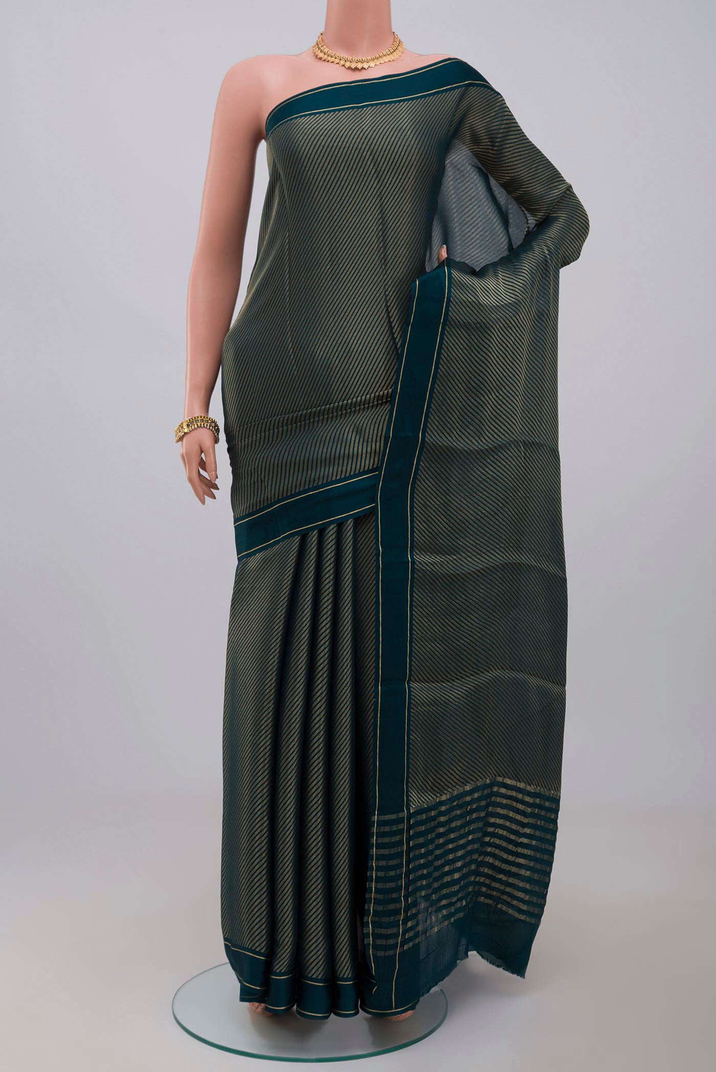 Blue Crepe Saree with Fancy on the body and Thin Zari Line.  displayed on a mannequin