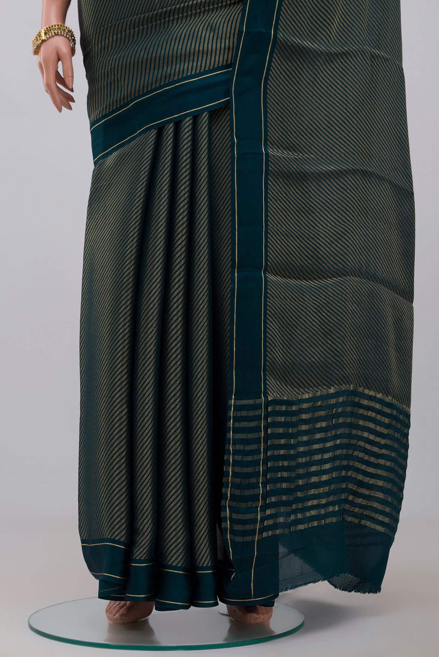 Pleats and pallu of Blue Crepe Saree with Fancy on the body and Thin Zari Line. 