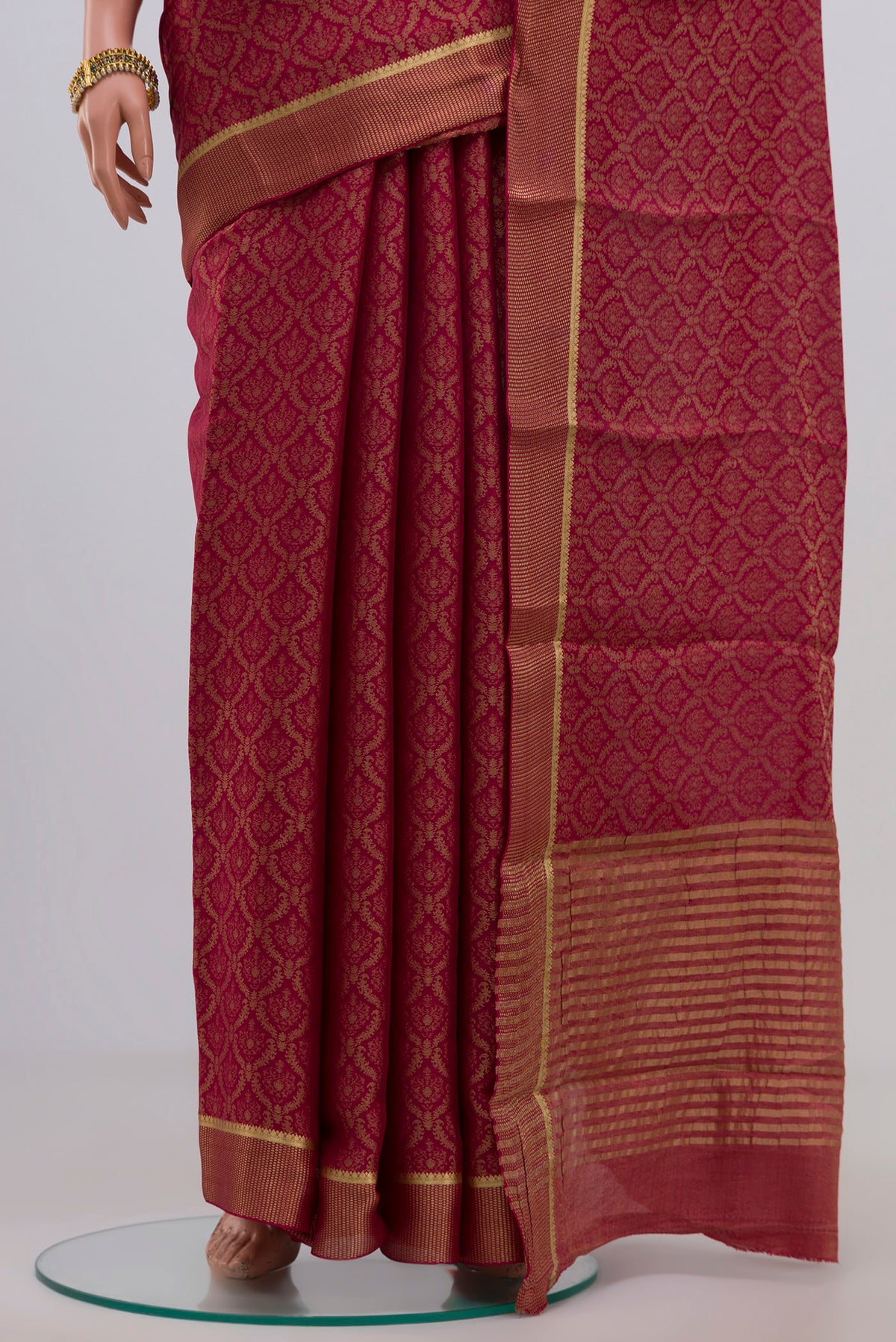 Pleats and pallu of Pink Georgette Saree with Zari Brocade on the body and Zari Border. 