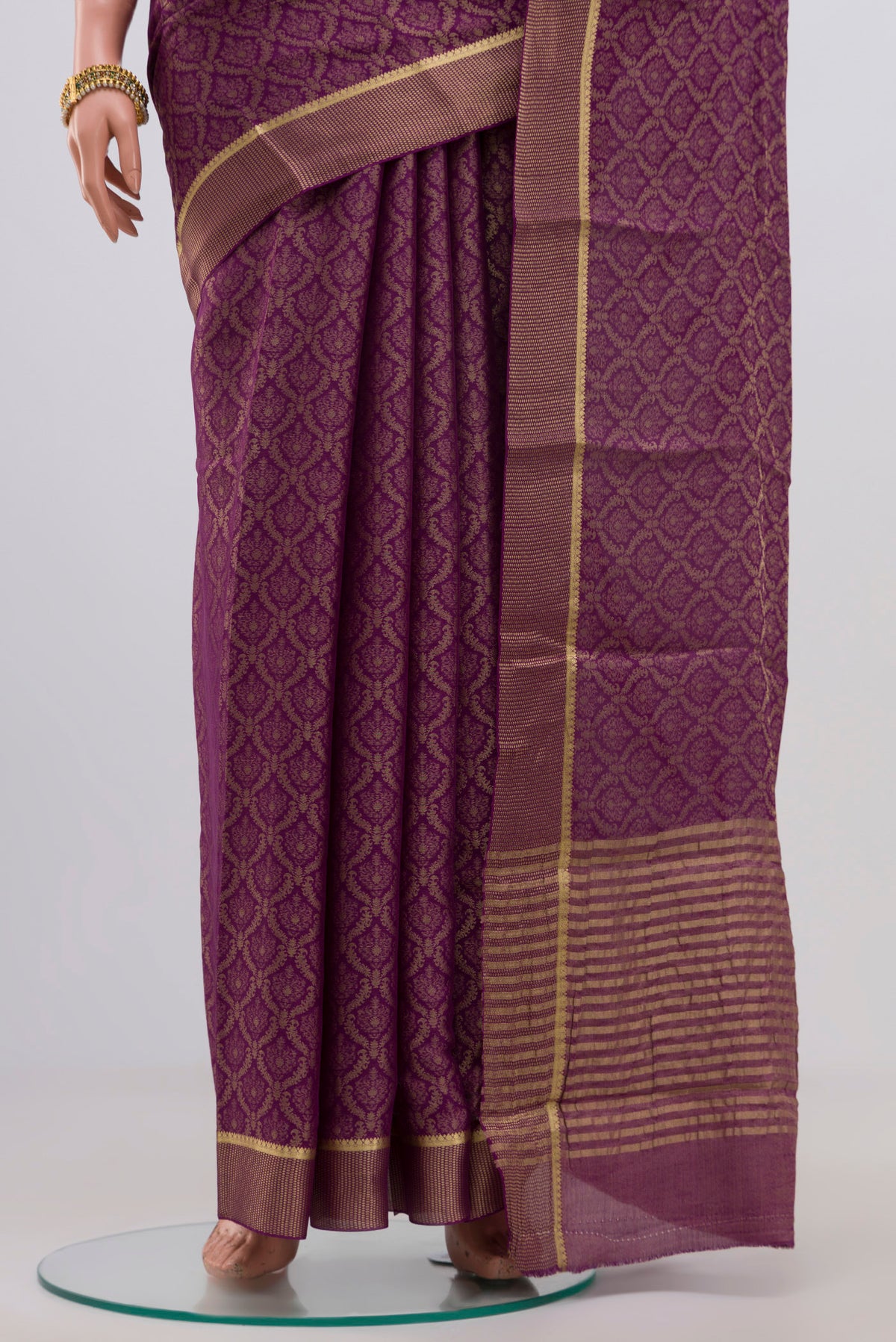 Pleats and pallu of Purple Georgette Saree with Zari Brocade on the body and Zari Border. 