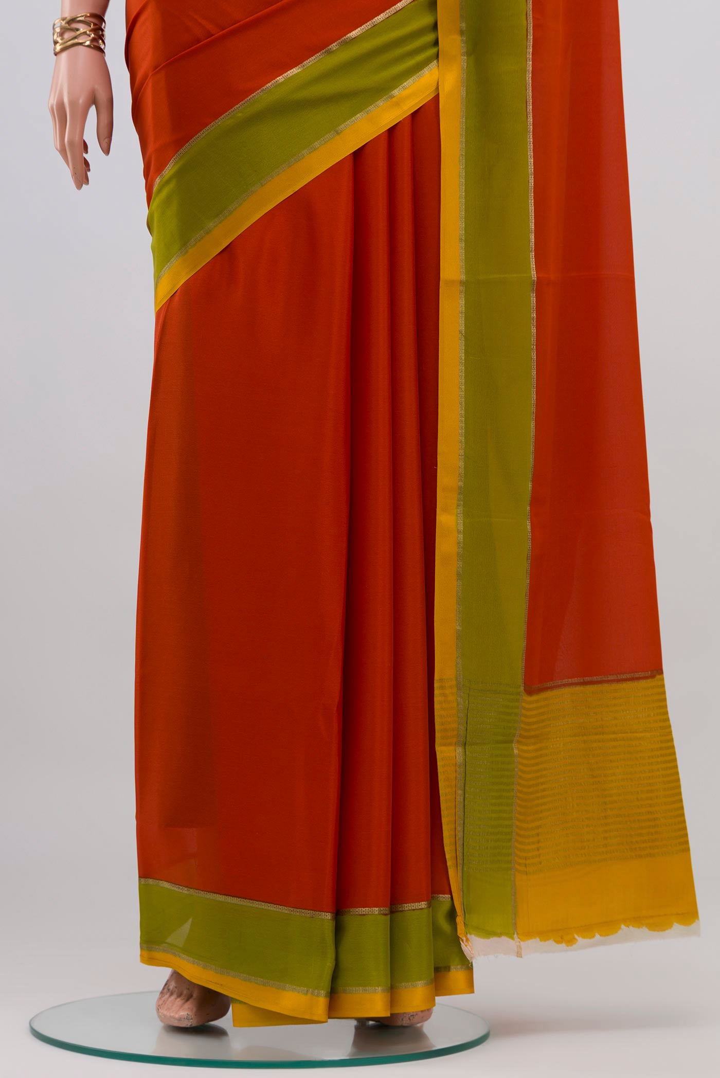 Pleats and pallu of Orange Mysore Crepe Saree with Plain Body and Plain Border. 