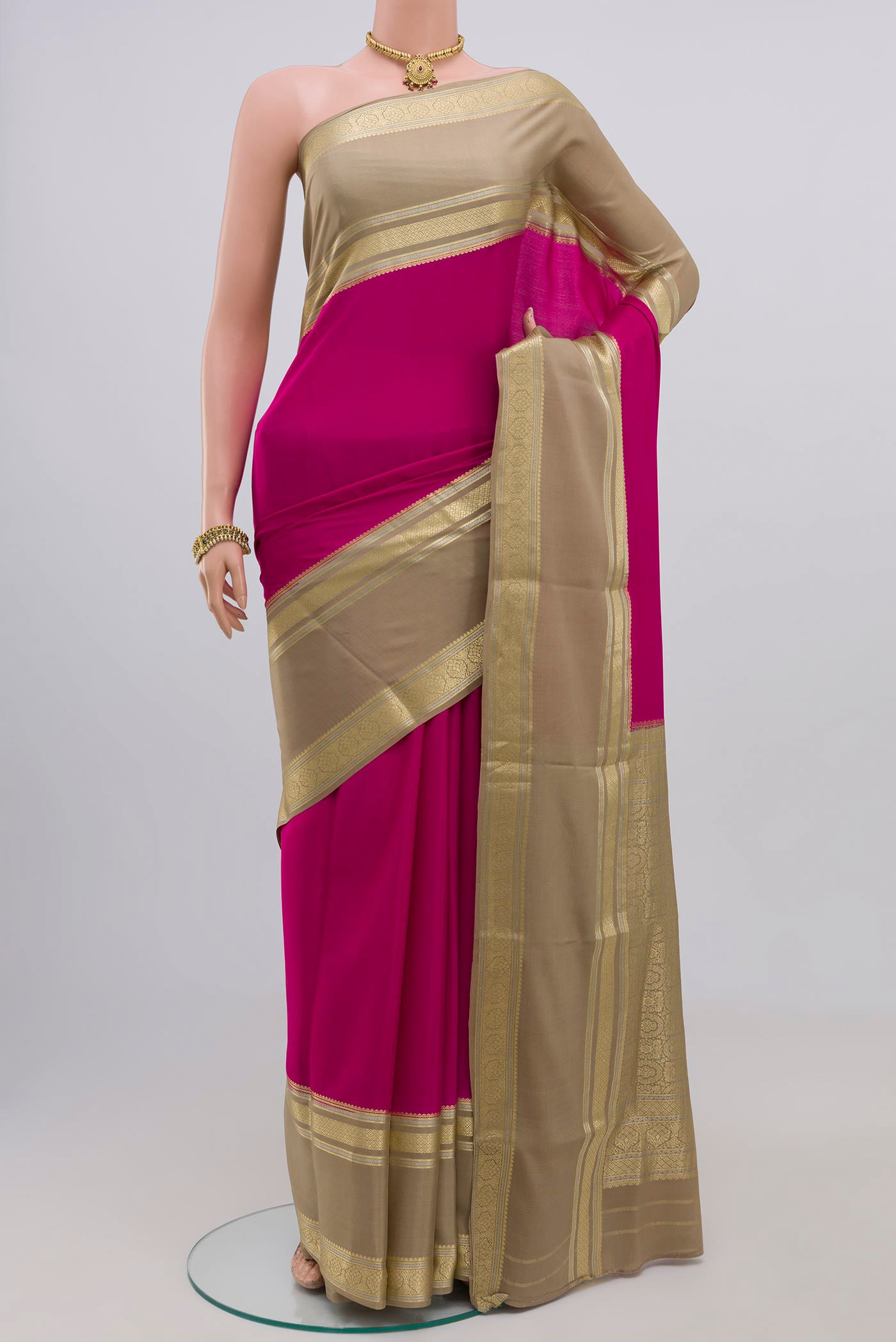 Pink Crepe Saree with Plain Body and Zari Border.  displayed on a mannequin