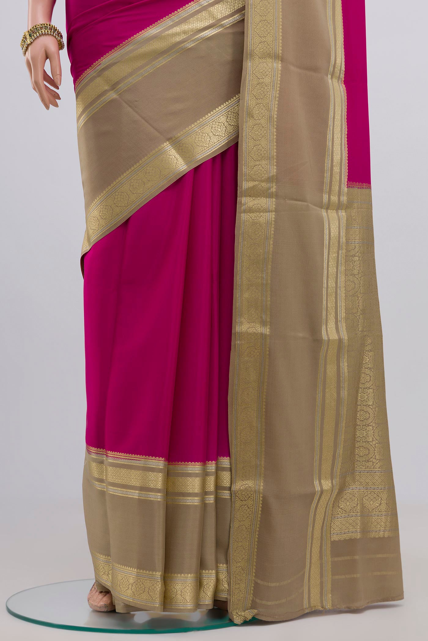 Pleats and pallu of Pink Crepe Saree with Plain Body and Zari Border. 