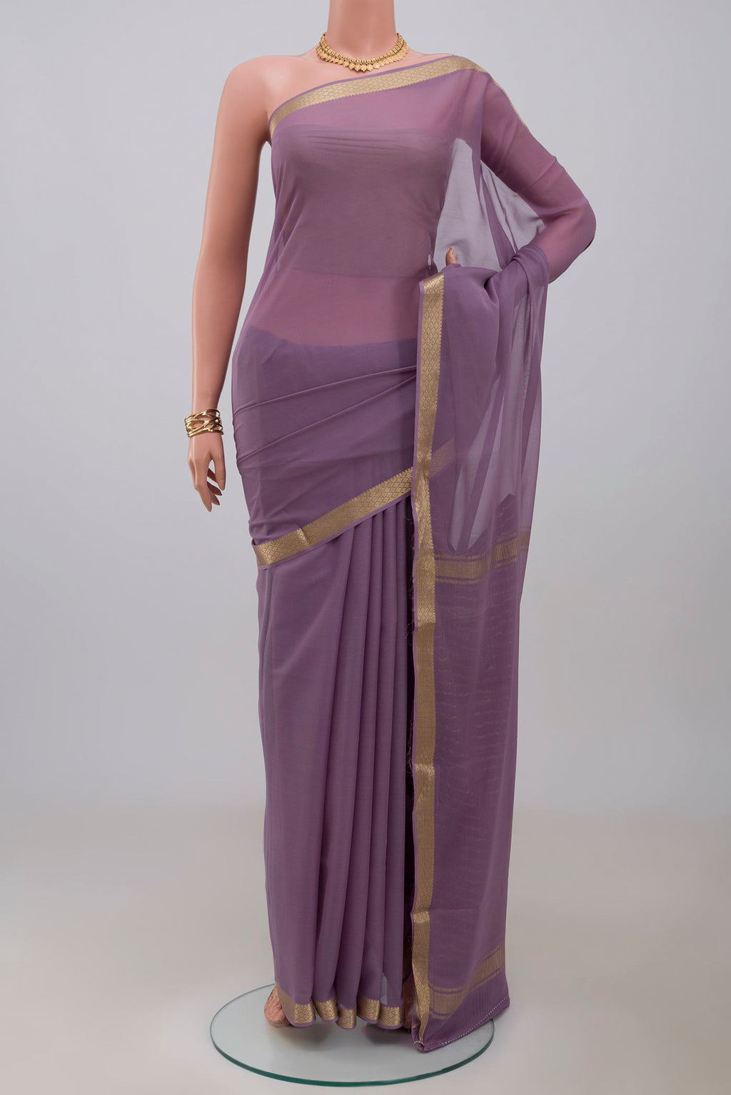 Lavender Georgette Saree with Plain Body and Zari Border.  displayed on a mannequin