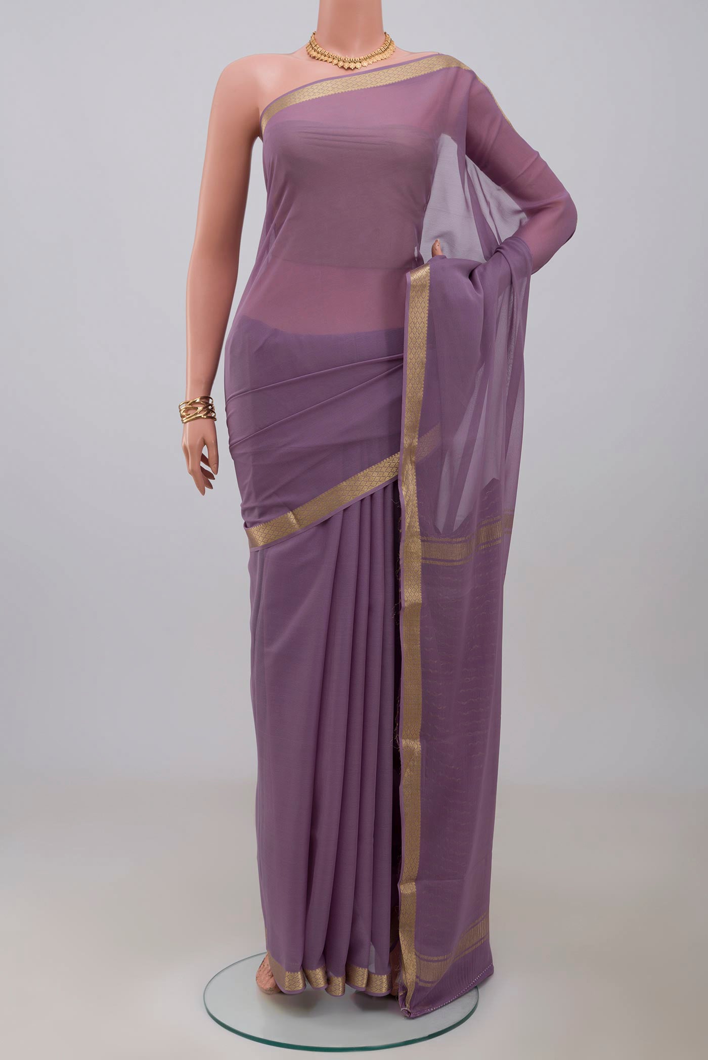 Lavender Georgette Saree with Plain Body and Zari Border.  displayed on a mannequin