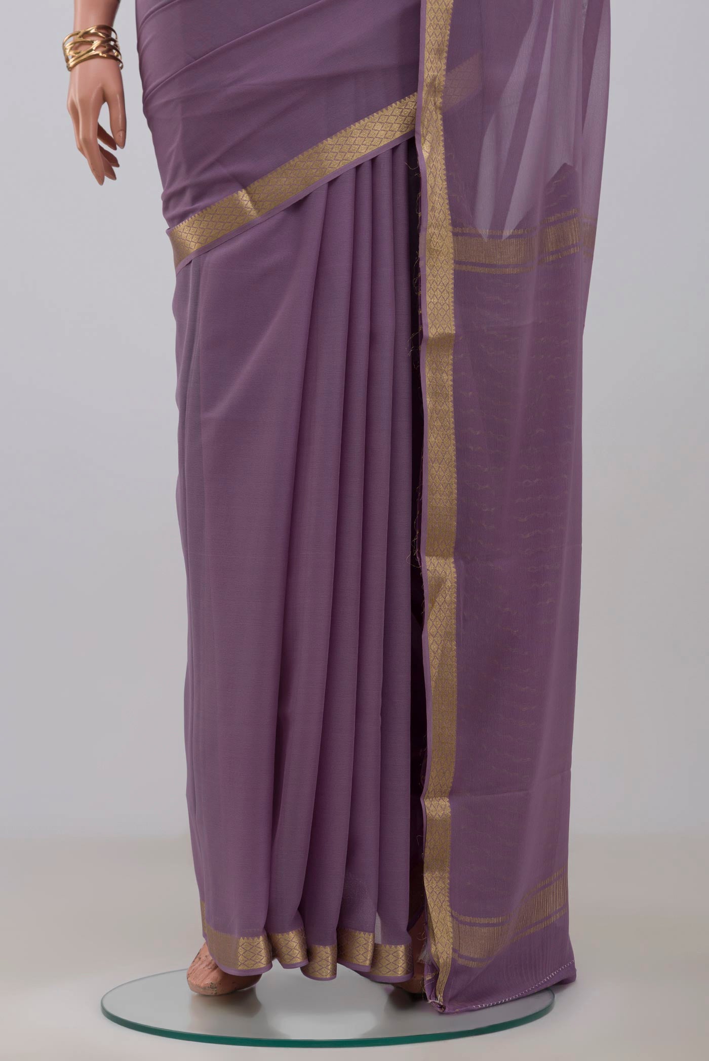 Pleats and pallu of Lavender Georgette Saree with Plain Body and Zari Border. 