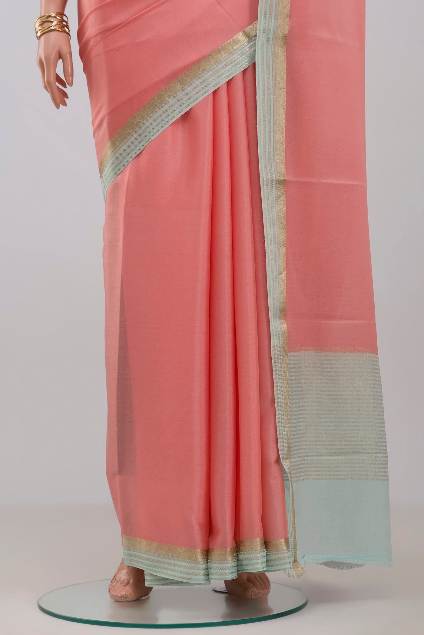 Pleats and pallu of Pink Crepe Saree with Plain Body and Fancy Border. 