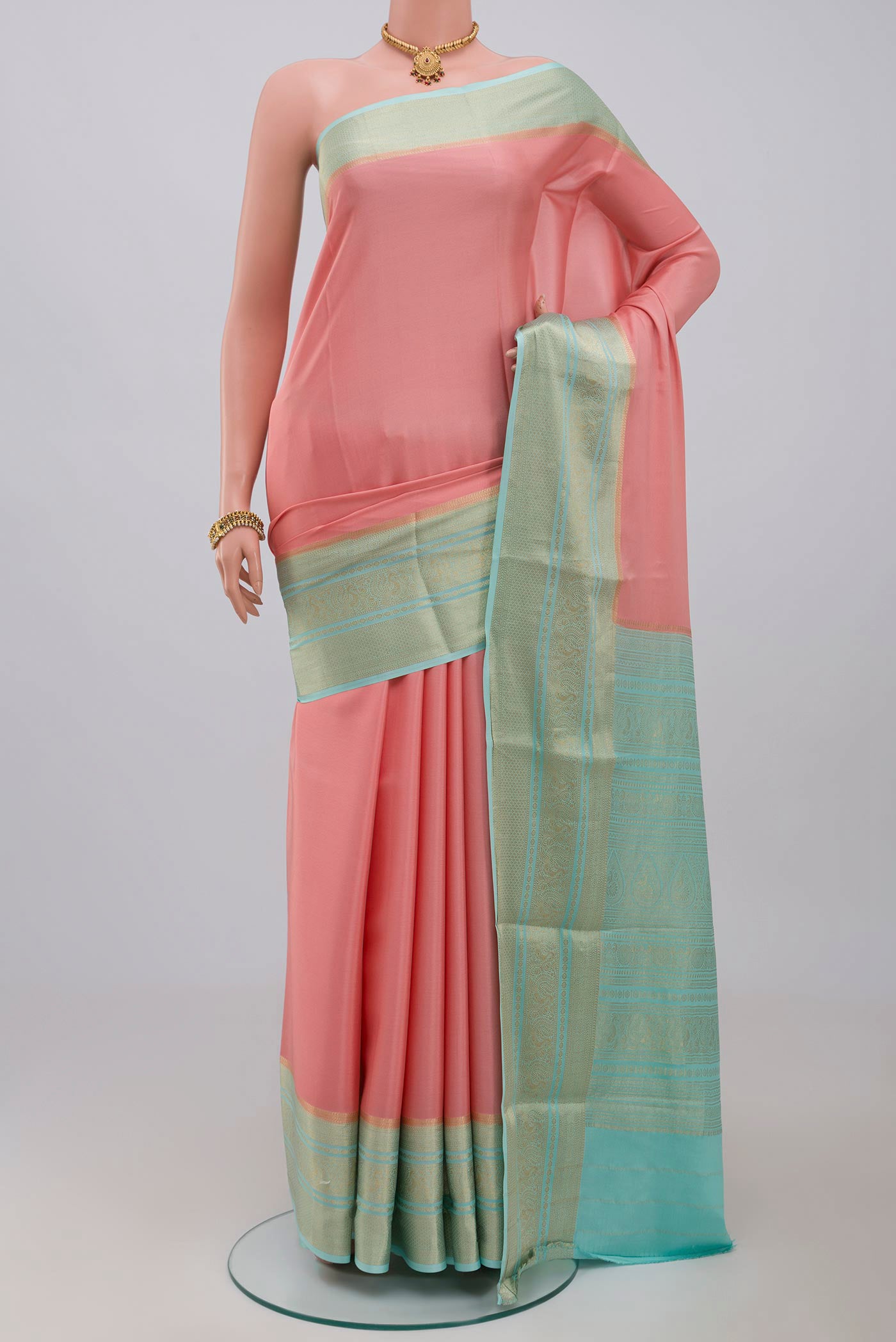Pink Crepe Saree with Plain Body and Zari Border.  displayed on a mannequin