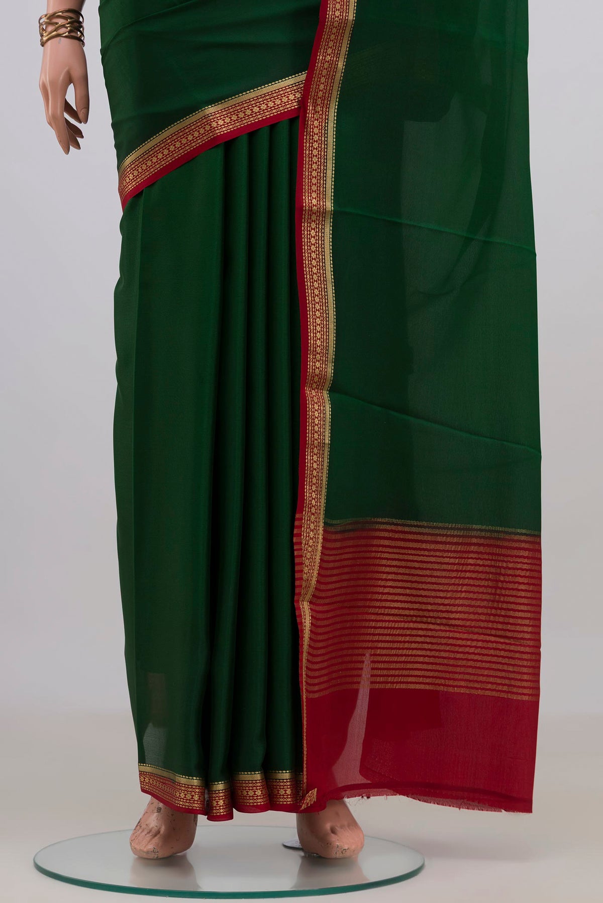 Pleats and pallu of Bottle Green Mysore Crepe Saree with Plain Body and Zari Border. 