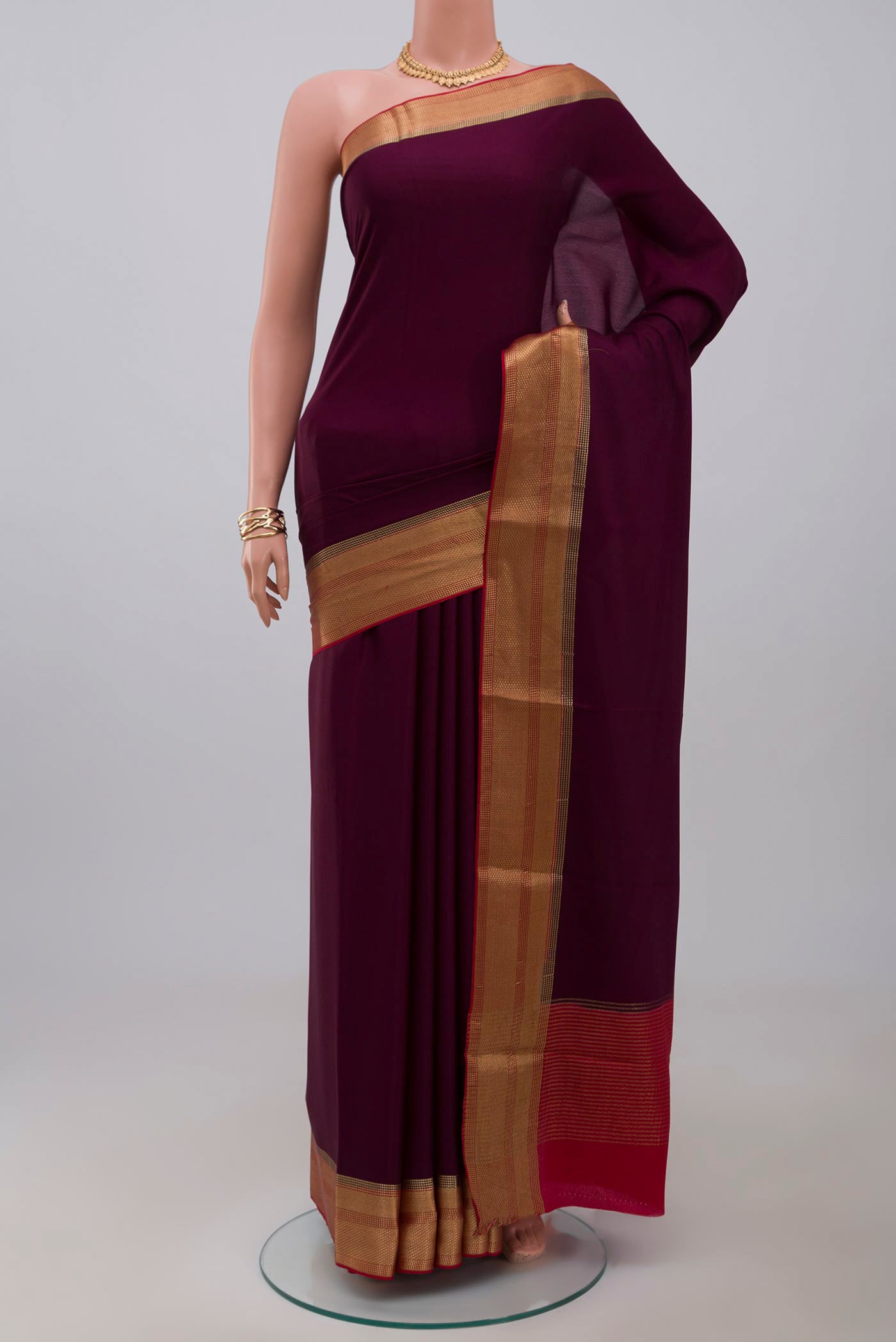 Purple Crepe Saree with Plain Body and Zari Border.  displayed on a mannequin