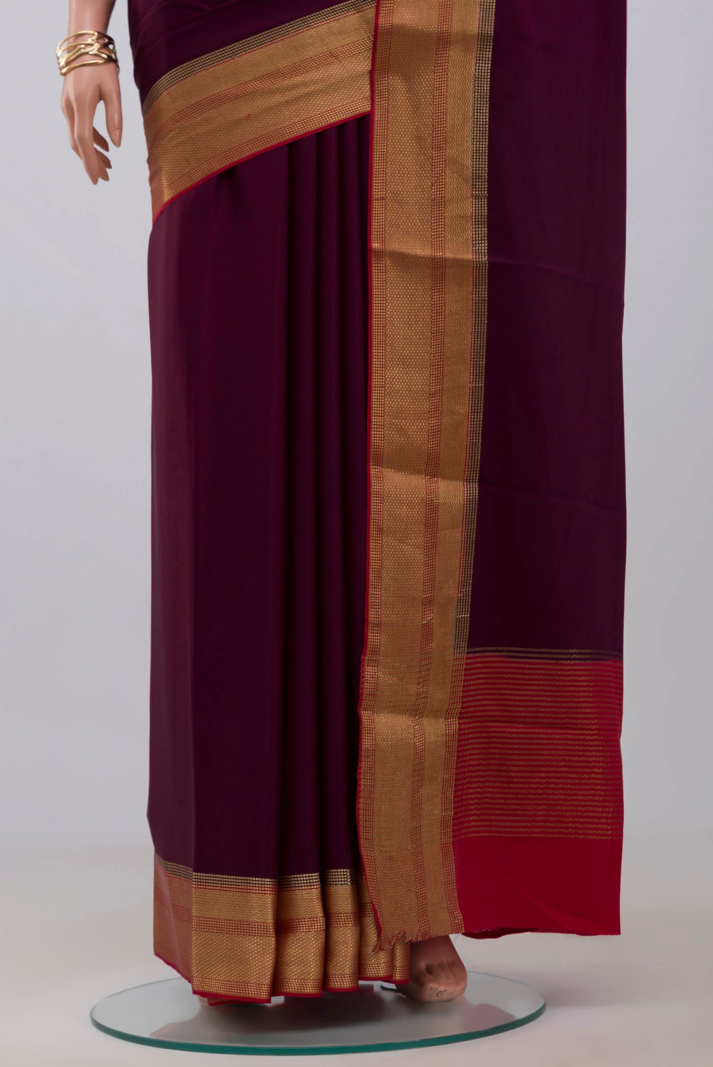 Pleats and pallu of Purple Crepe Saree with Plain Body and Zari Border. 