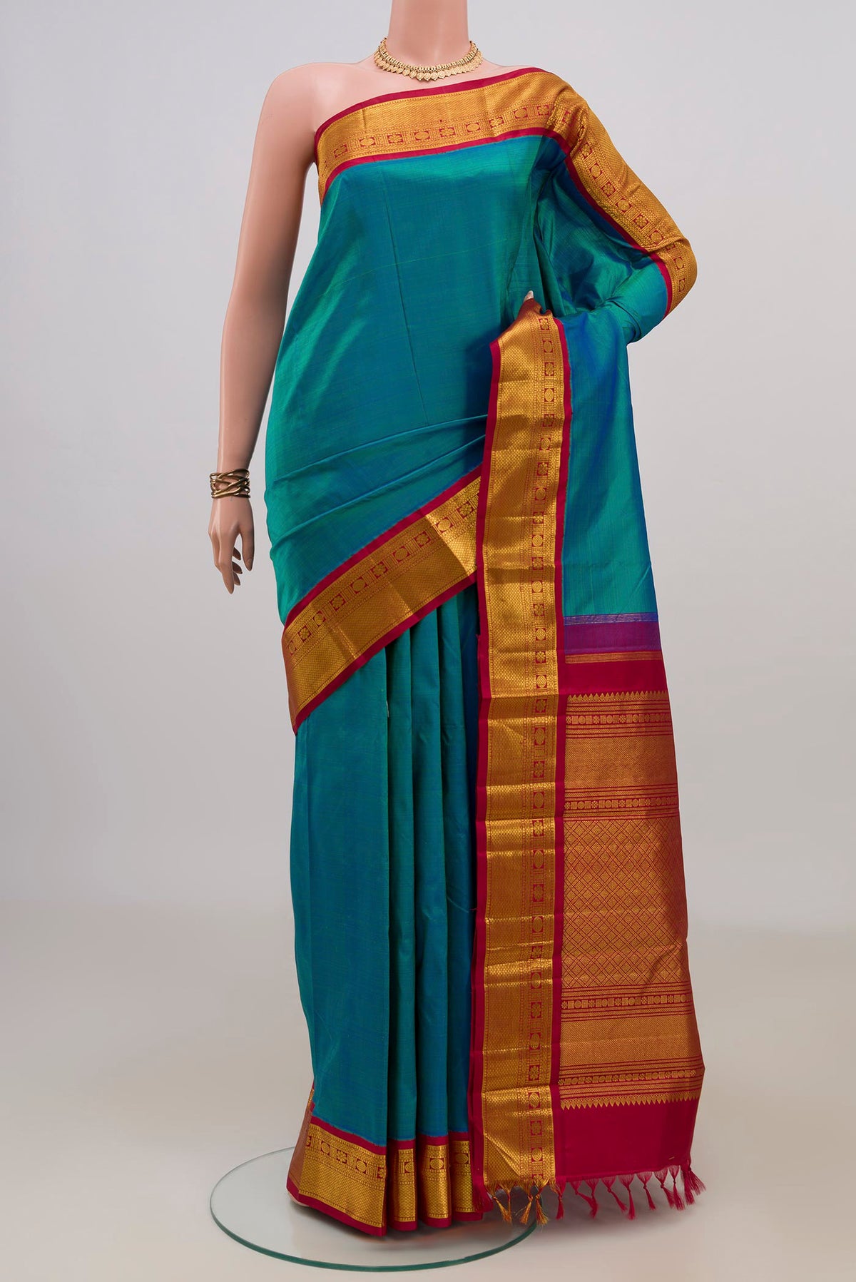 Pure Silk Blue Kanjivaram Saree with Plain Body and Zari Border.  displayed on a mannequin