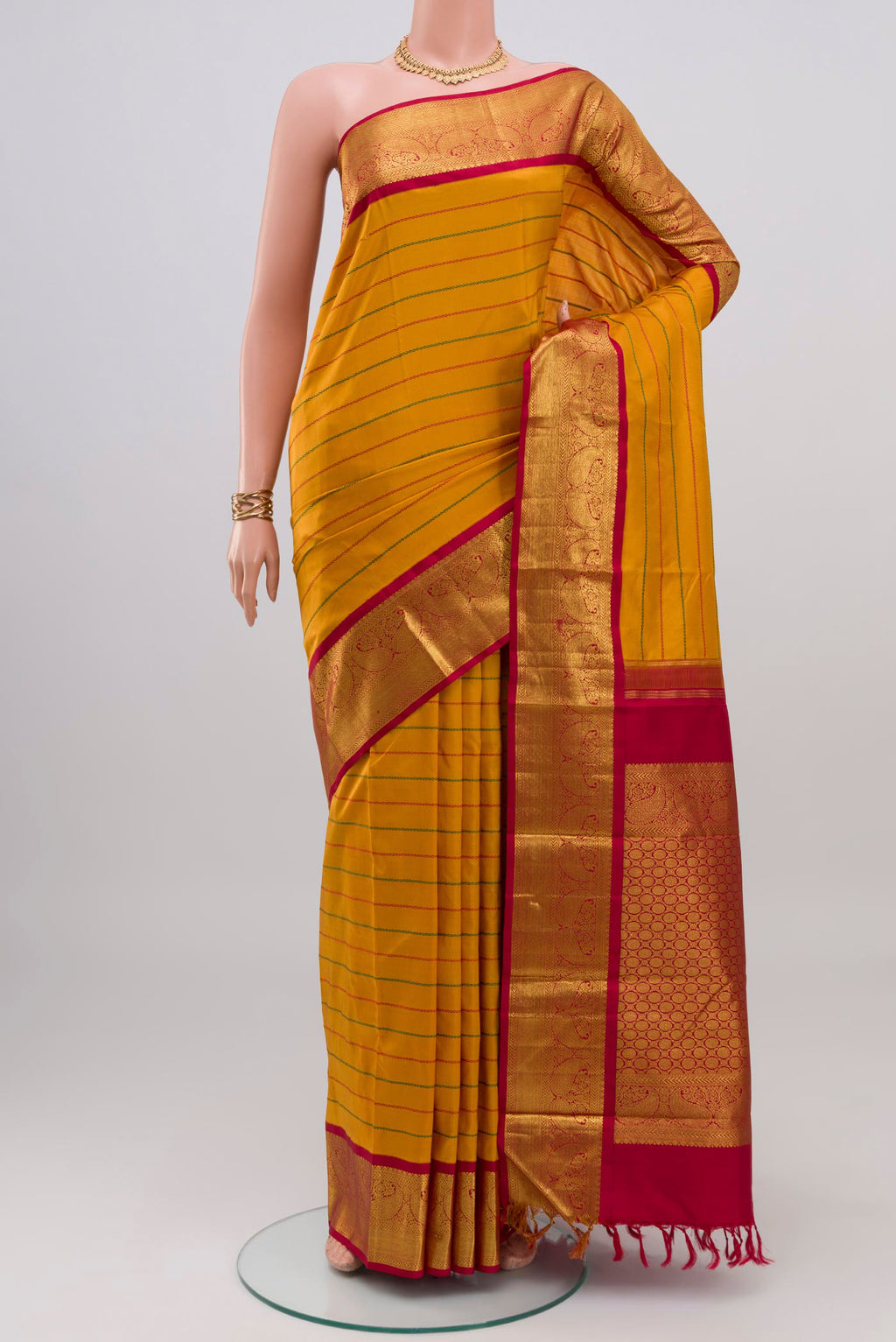 Yellow Kanjivaram Silk Saree with Veldhari on the body and Zari Border.  displayed on a mannequin