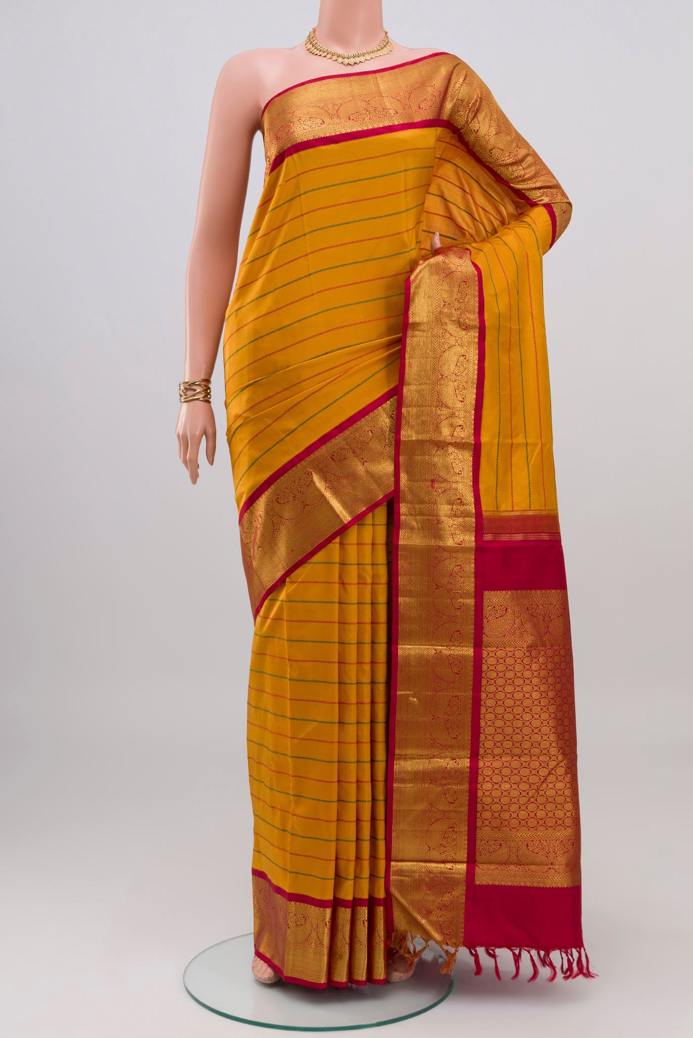 Yellow Kanjivaram Silk Saree with Veldhari on the body and Zari Border.  displayed on a mannequin