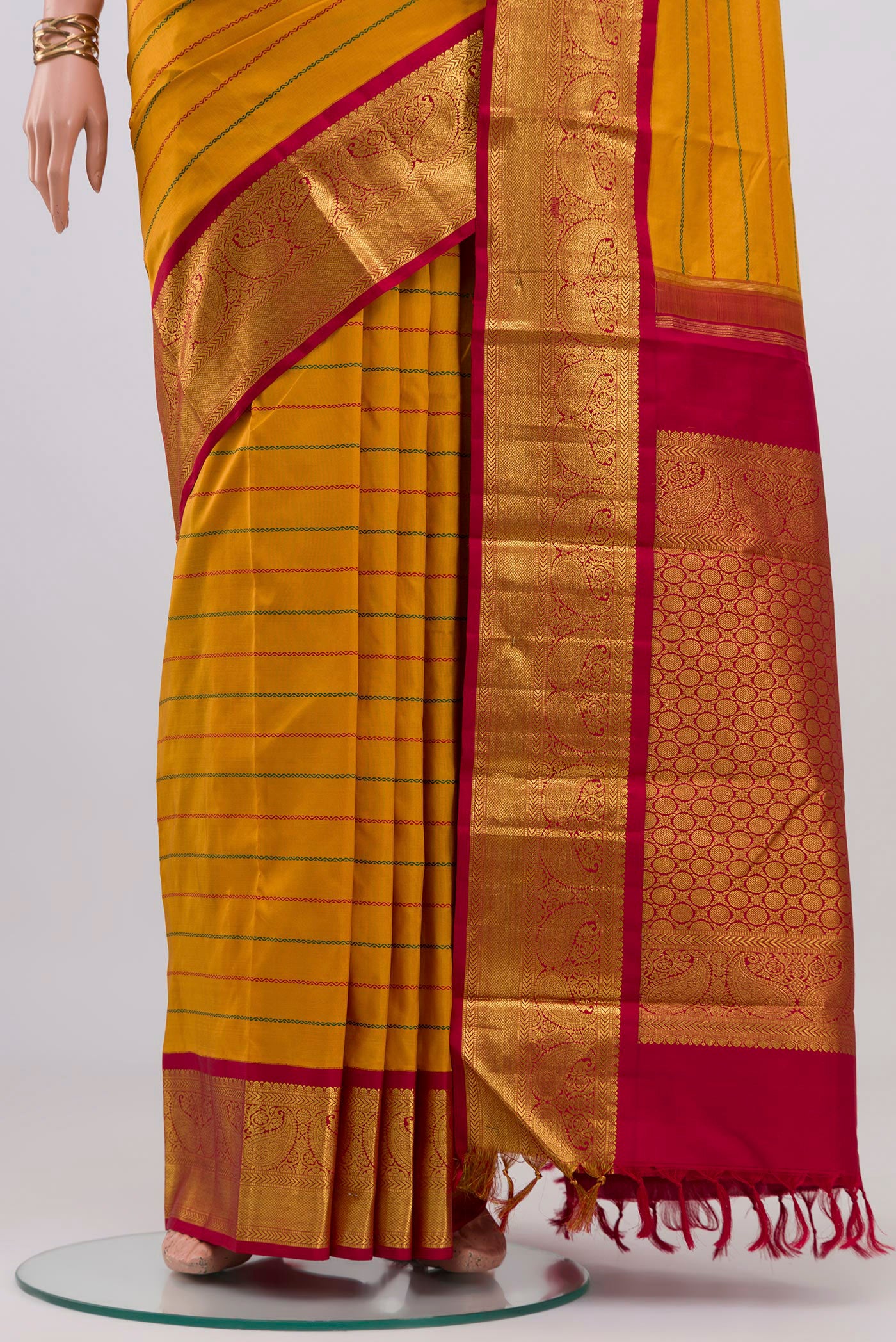 Pleats and pallu of Yellow Kanjivaram Silk Saree with Veldhari on the body and Zari Border. 