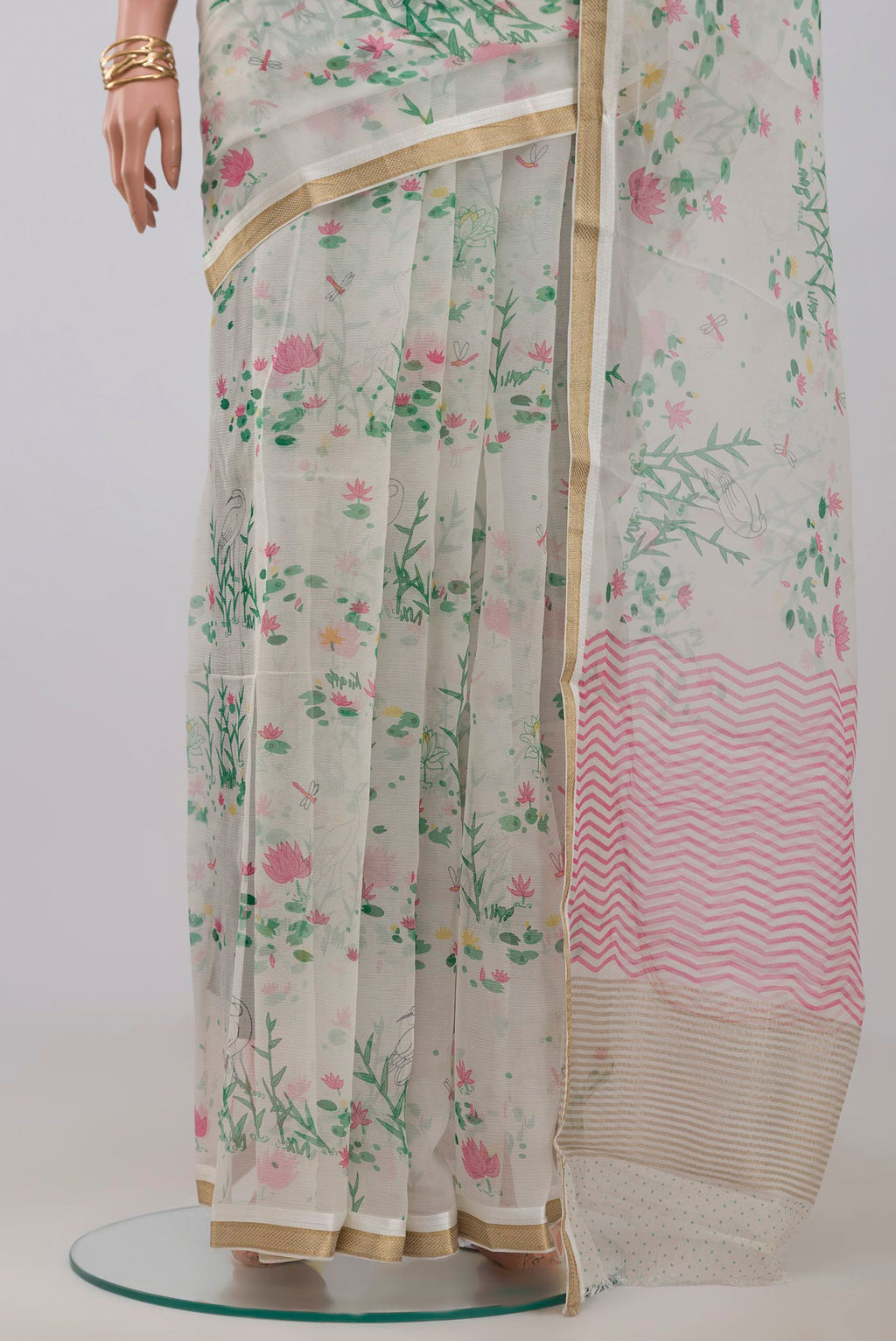 Pleats and pallu of White Chiffon Saree with Printed design on the body and Zari Border. 