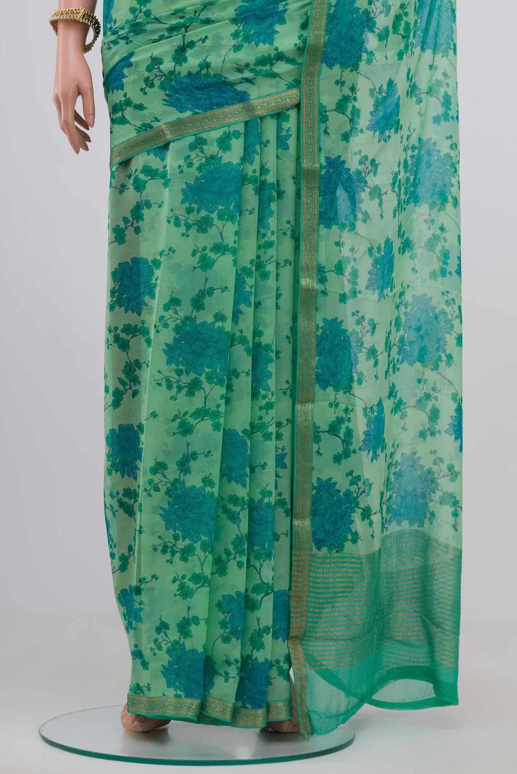 Pleats and pallu of Pista Green Chiffon Saree with Printed design on the body and Zari Border. 