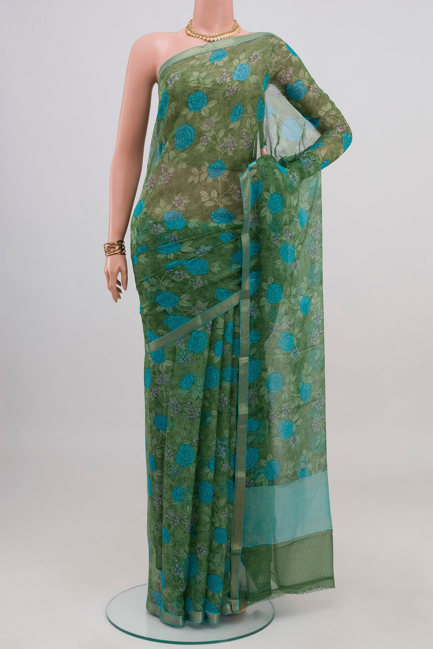 Green Mysore Chiffon Saree with Floral Print on the body and Zari Border.  displayed on a mannequin