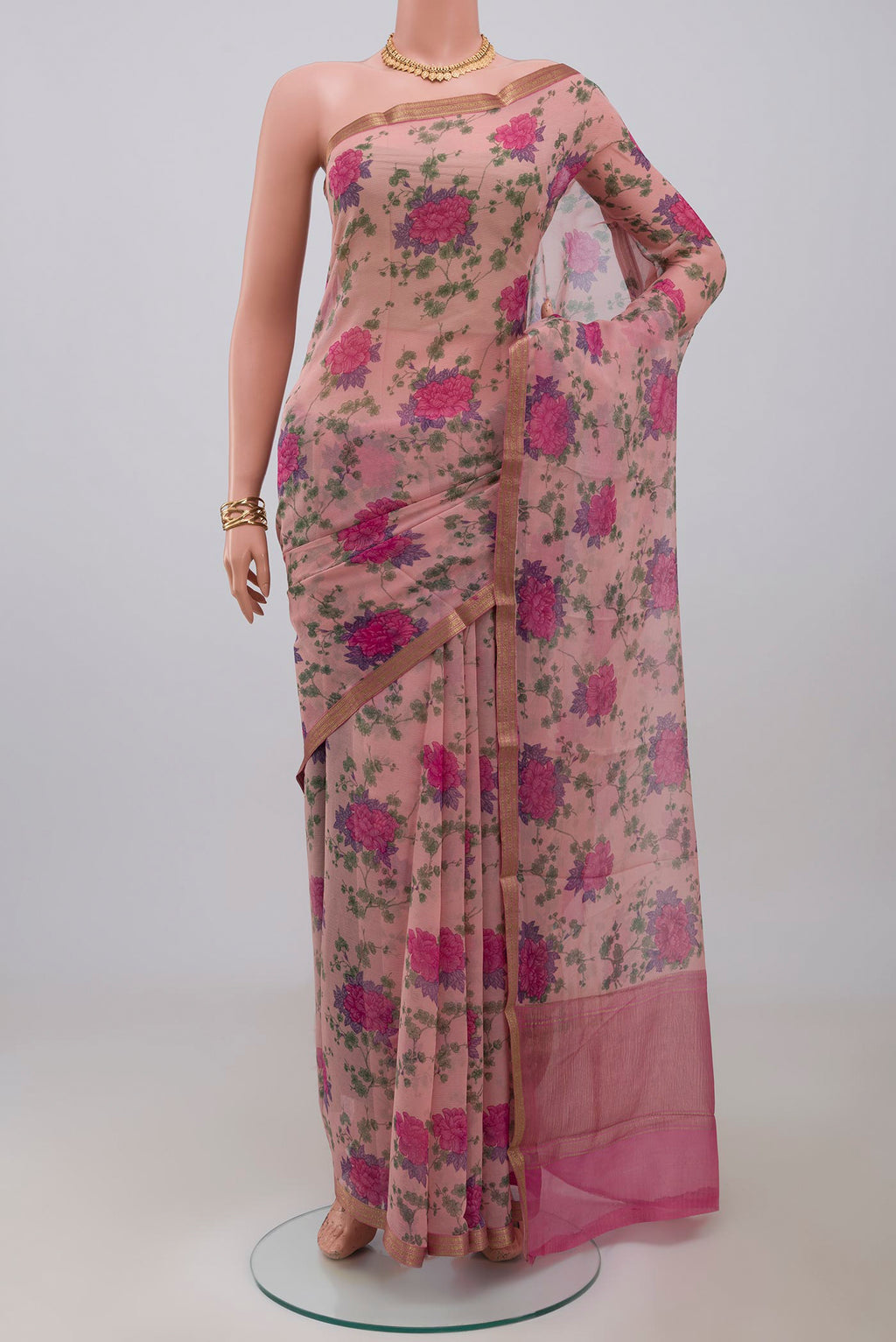 Pink Chiffon Saree with Printed design on the body and Zari Border.  displayed on a mannequin