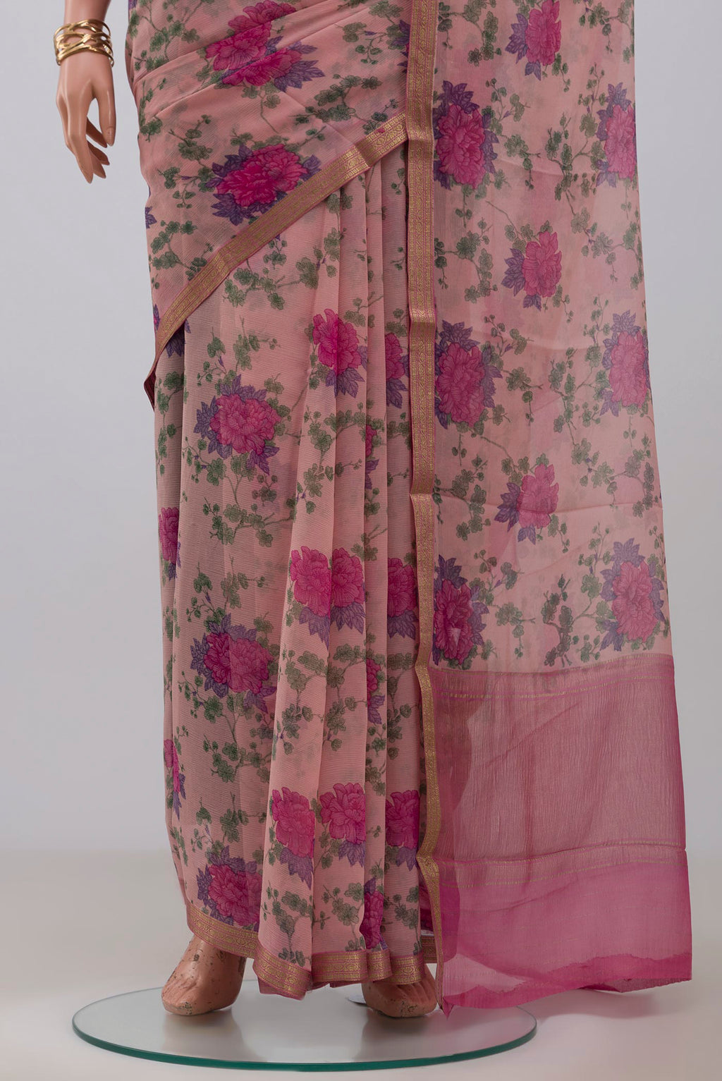 Pleats and pallu of Pink Chiffon Saree with Printed design on the body and Zari Border. 