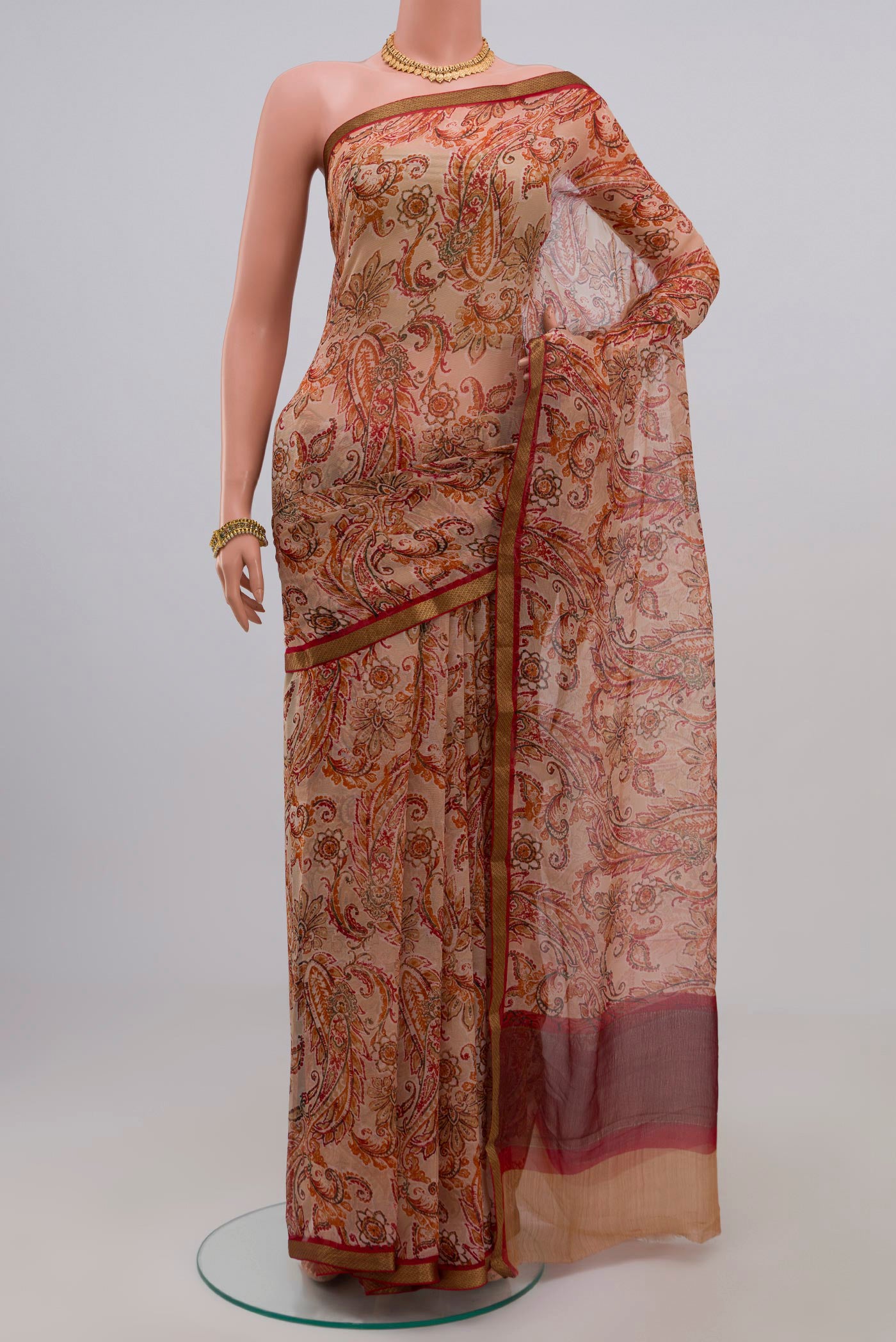 Cream Chiffon Saree with Printed design on the body and Zari Border.  displayed on a mannequin
