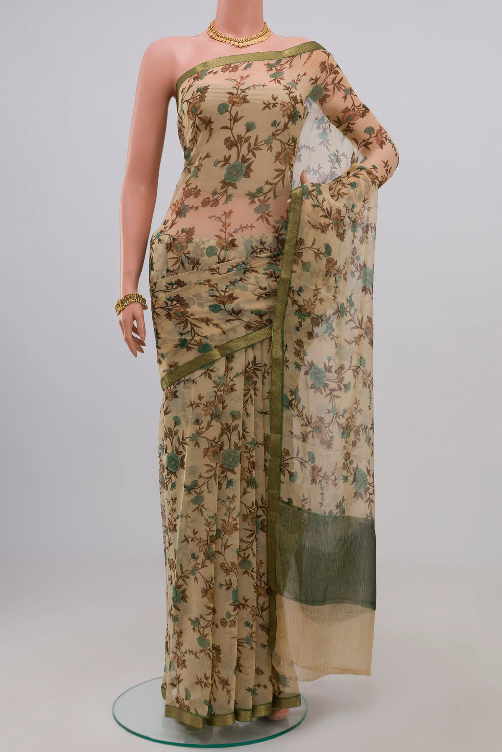 Cream Chiffon Saree with Printed design on the body and Zari Border.  displayed on a mannequin