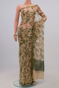 Cream Chiffon Saree with Printed design on the body and Zari Border.  displayed on a mannequin