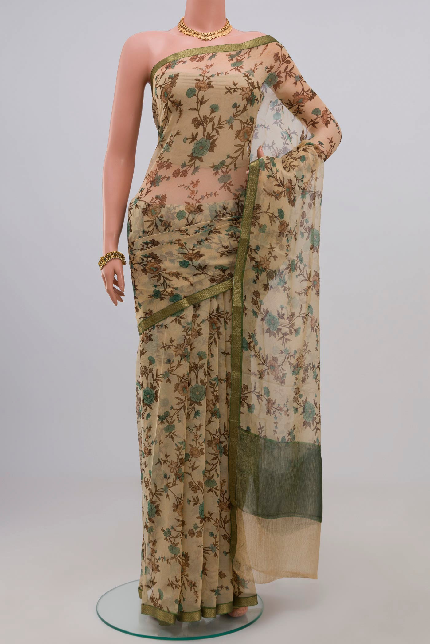 Cream Chiffon Saree with Printed design on the body and Zari Border.  displayed on a mannequin