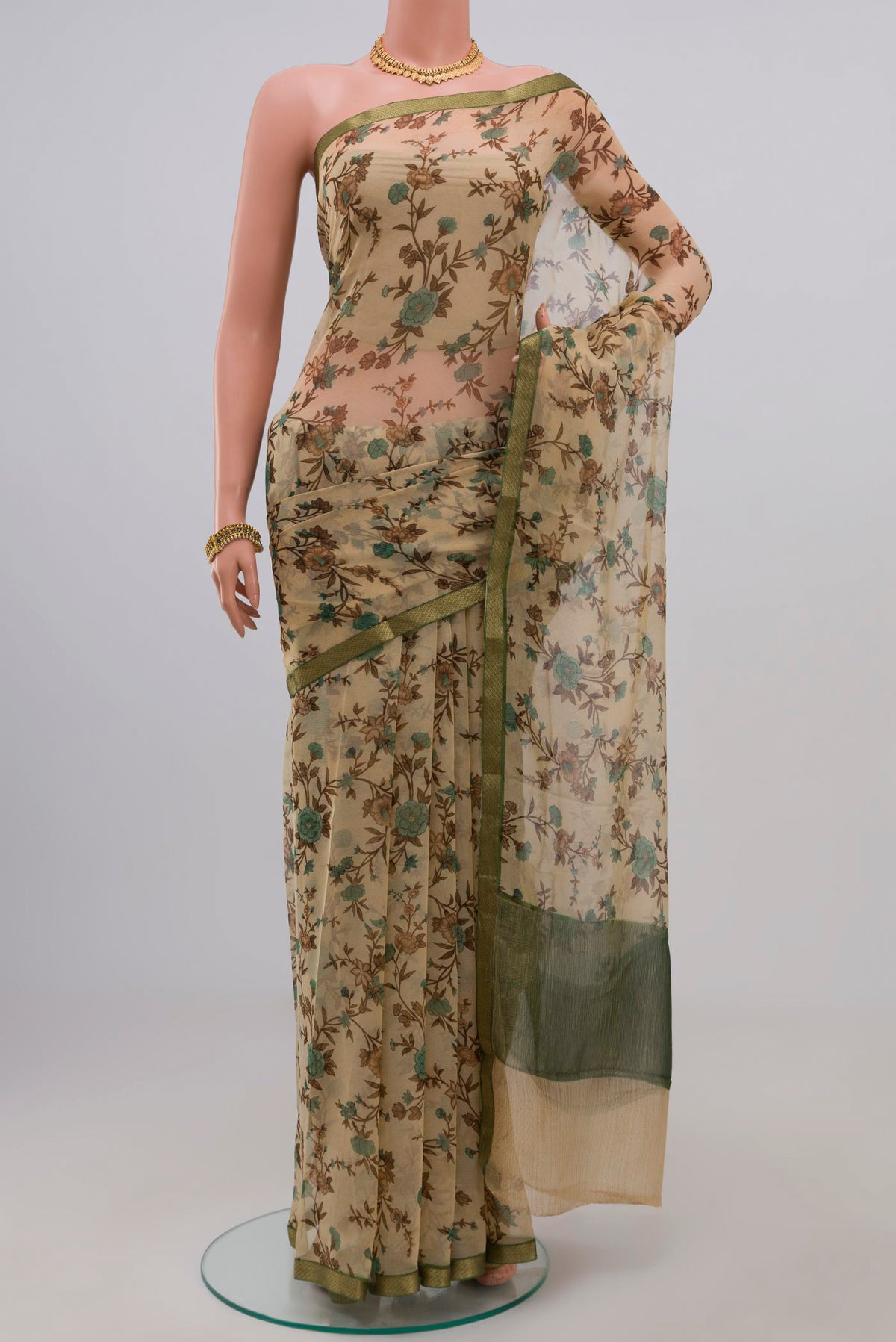 Cream Chiffon Saree with Printed design on the body and Zari Border.  displayed on a mannequin