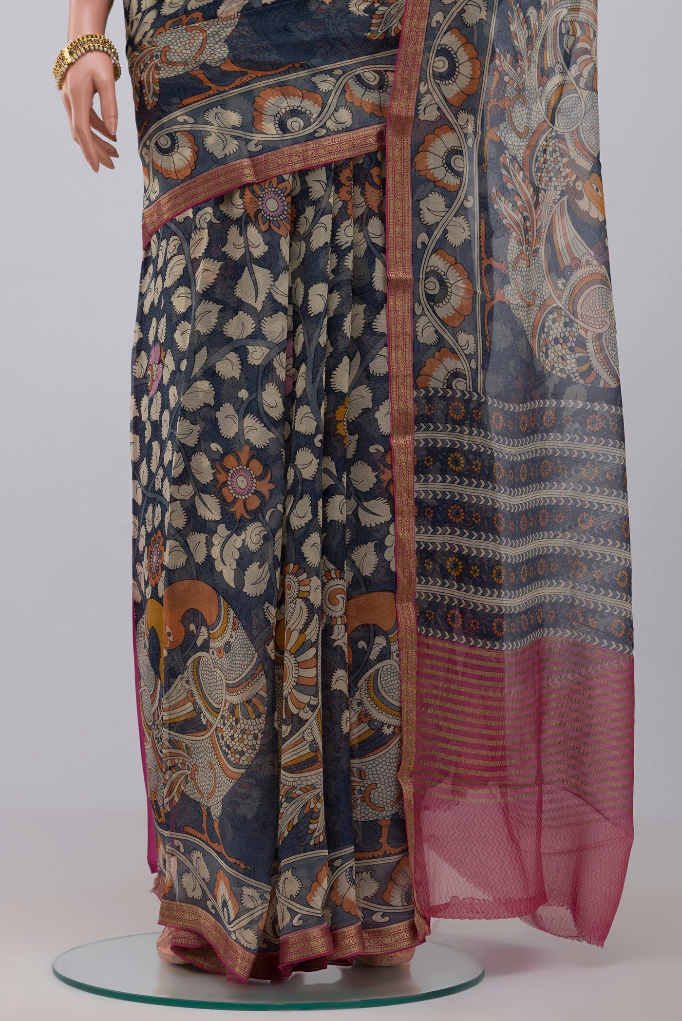 Pleats and pallu of Blue Chiffon Saree with Printed design on the body and Thin Zari Line. 
