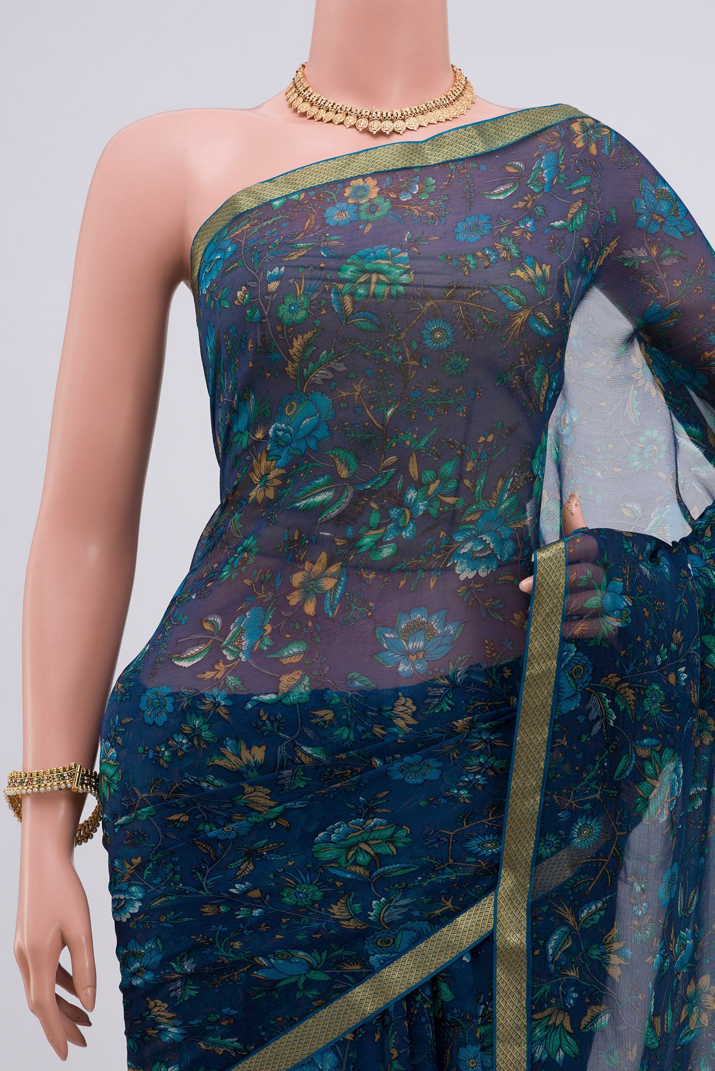Border image of Blue Chiffon Saree with Printed design on the body and Zari Border. 