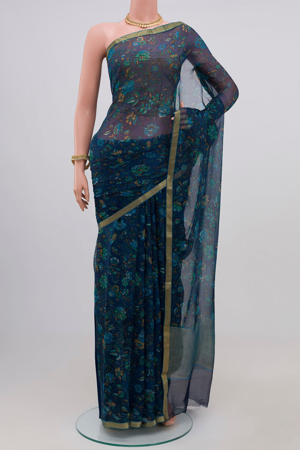 Blue Chiffon Saree with Printed design on the body and Zari Border.  displayed on a mannequin