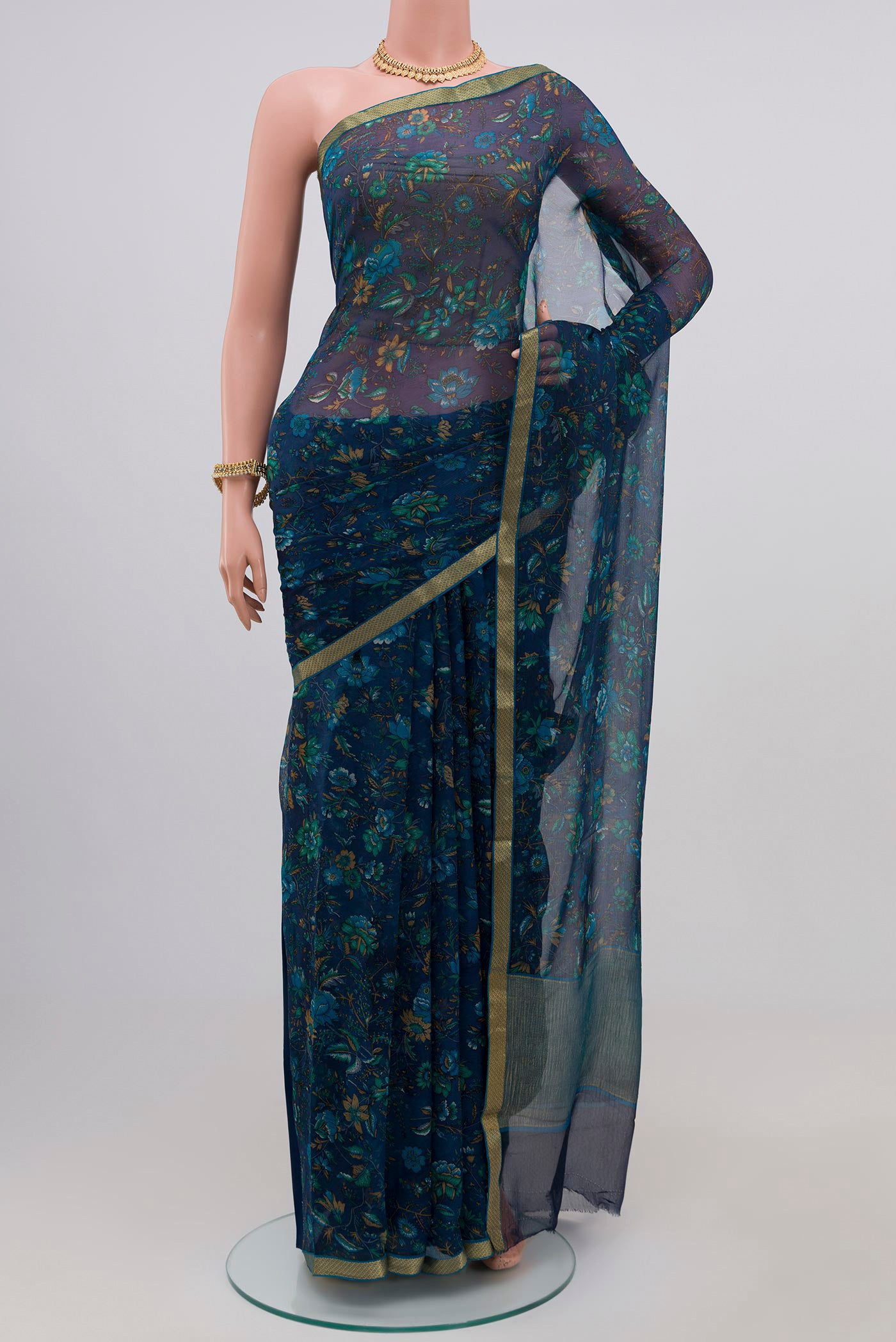 Blue Chiffon Saree with Printed design on the body and Zari Border.  displayed on a mannequin