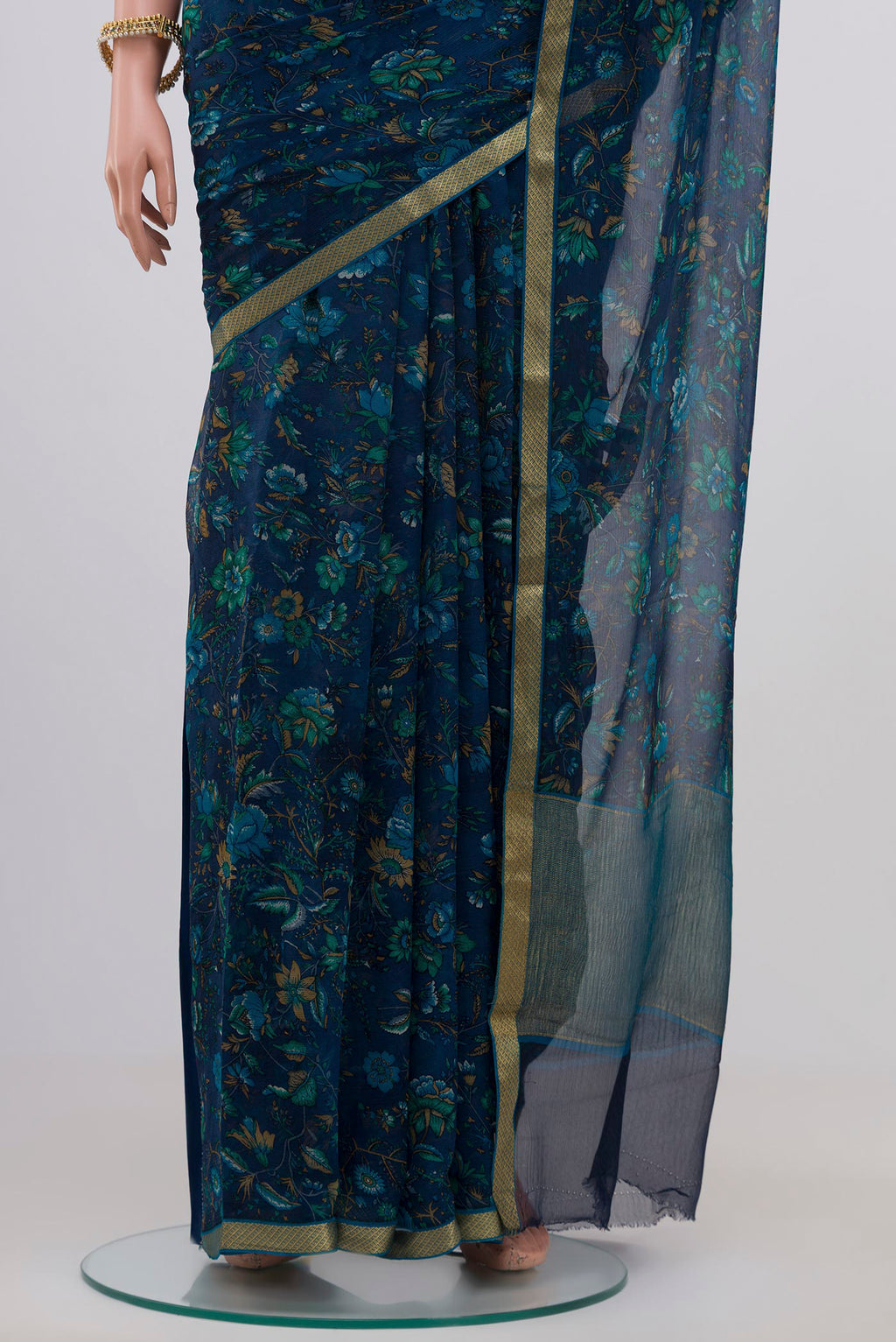 Pleats and pallu of Blue Chiffon Saree with Printed design on the body and Zari Border. 