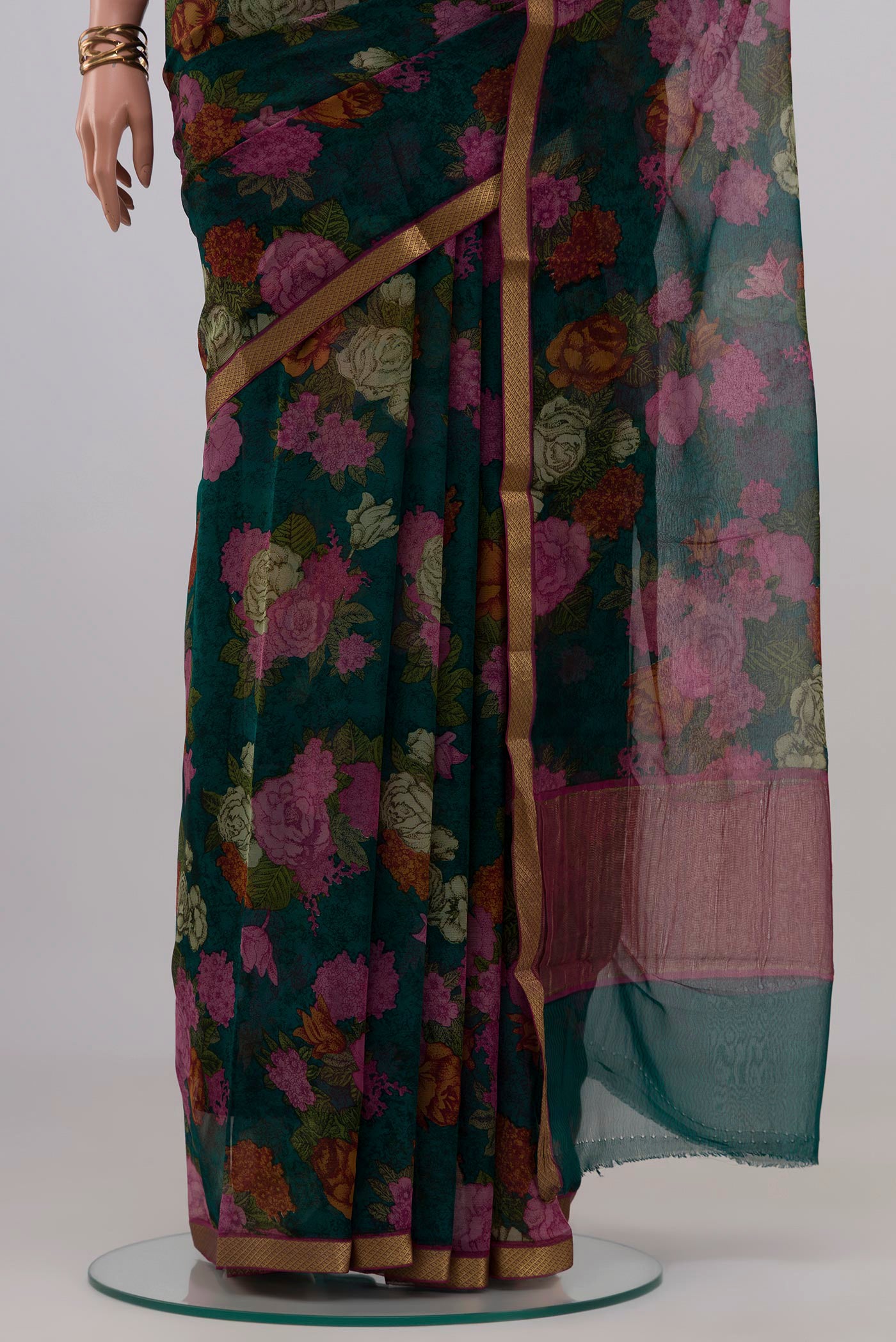 Pleats and pallu of Green Mysore Chiffon Saree with Floral Print on the body and Zari Border. 